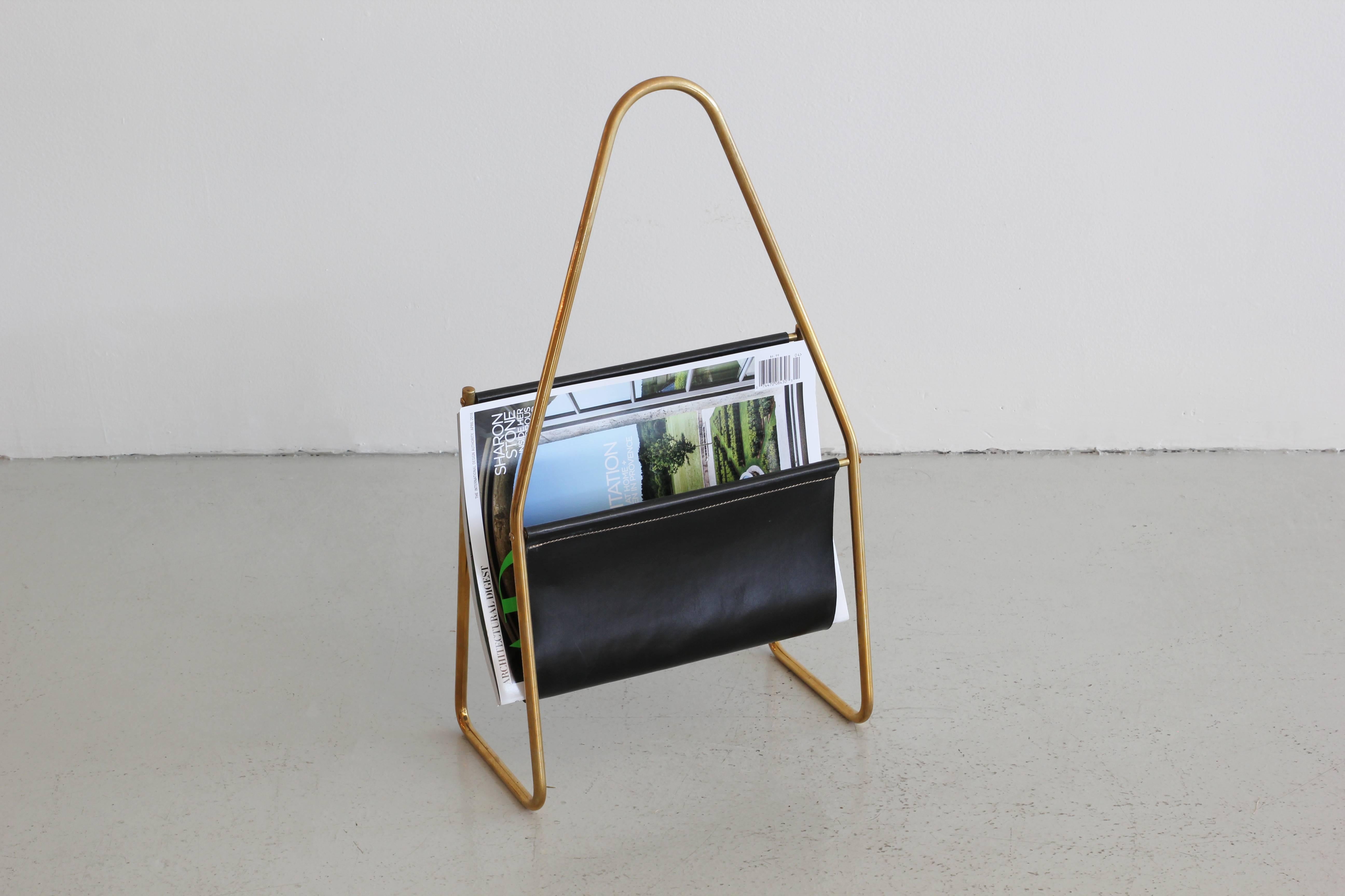 Elegant and simple leather and brass magazine stand by Carl Aubock.