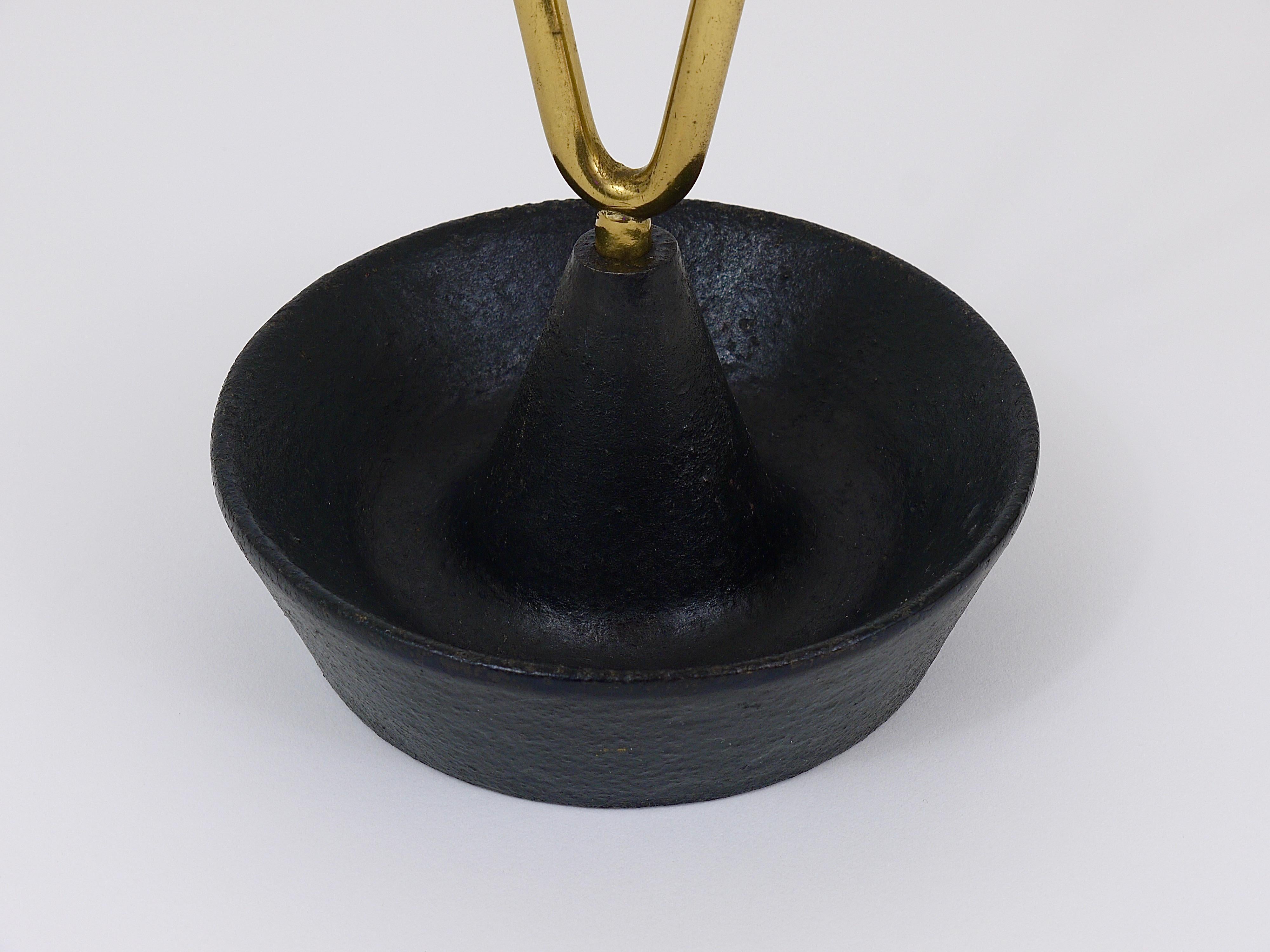 A straight and beautiful Austrian modernist umbrella stand, made of brass and cast iron. Designed and executed by Carl Auböck. A sophisticated piece, one of the most beautiful umbrella stands we know. In very good original condition with marginal