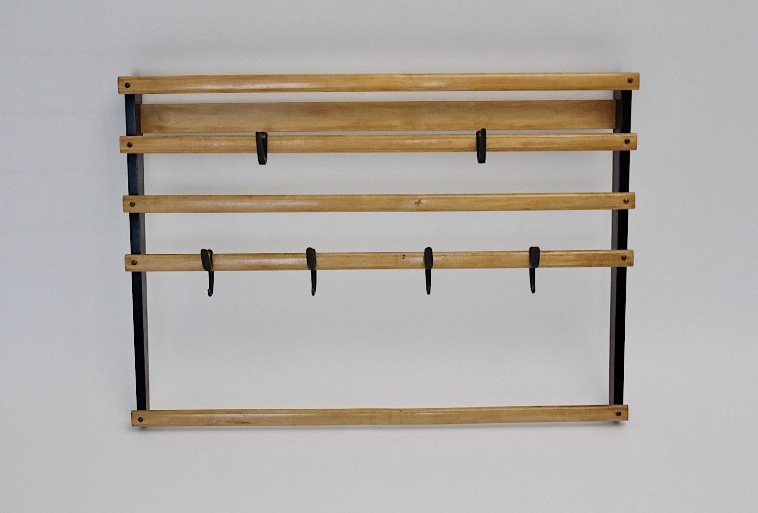 Mid-Century Modern vintage original Carl Auböck coat rack or wardrobe from beech with six brass hooks Vienna 1950s
While the wall mounted wardrobe or coat rack is made from black and colorless lacquered solid beech, the six hooks are partly