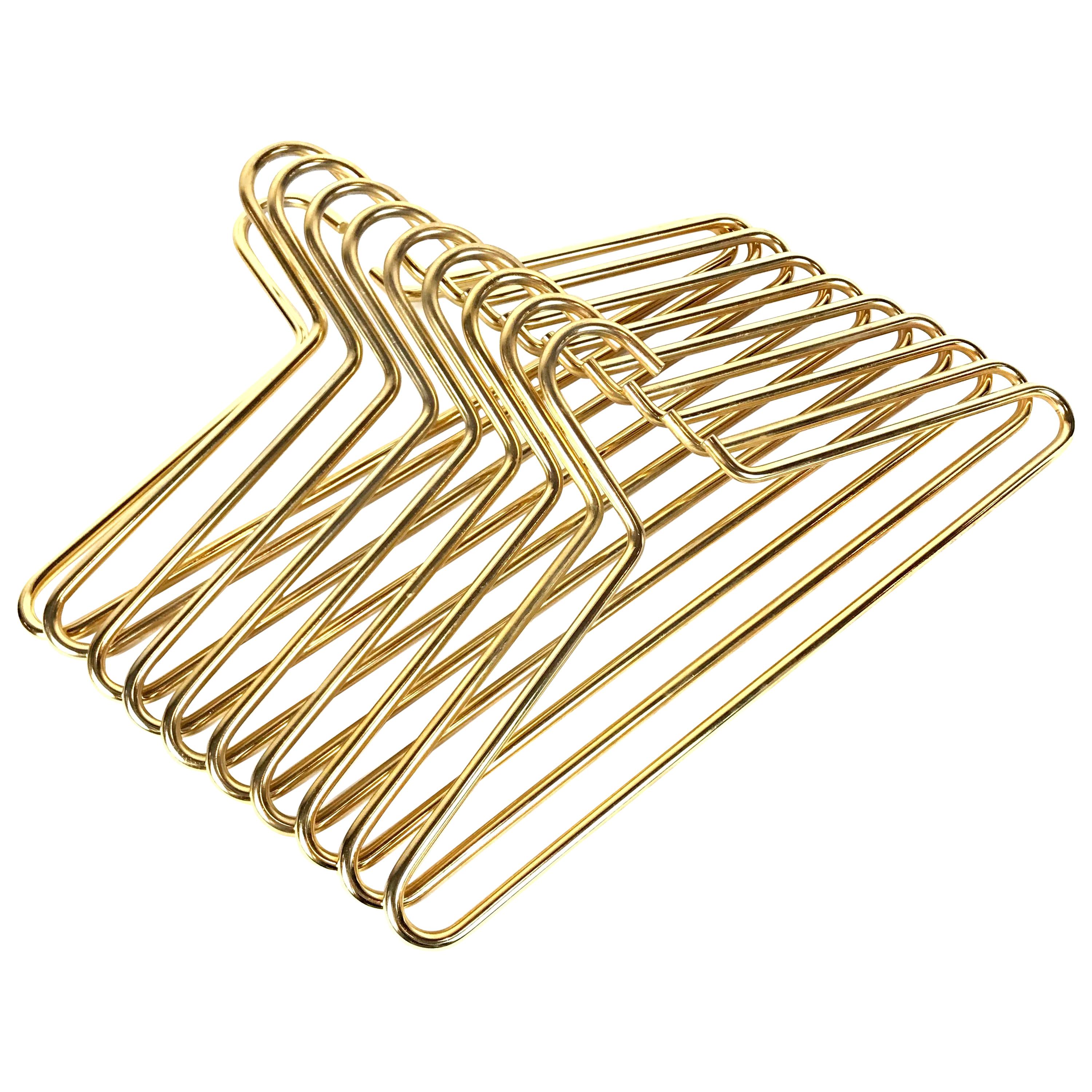 2 of 40 Beautiful Mid-Century Modern cloth hangers designed and manufactured by Carl Auböck in 1960s. They are made of brass-plated solid steel. Of almost continuous organic shape with only one gap at the hook to place the hangers on a rail. The