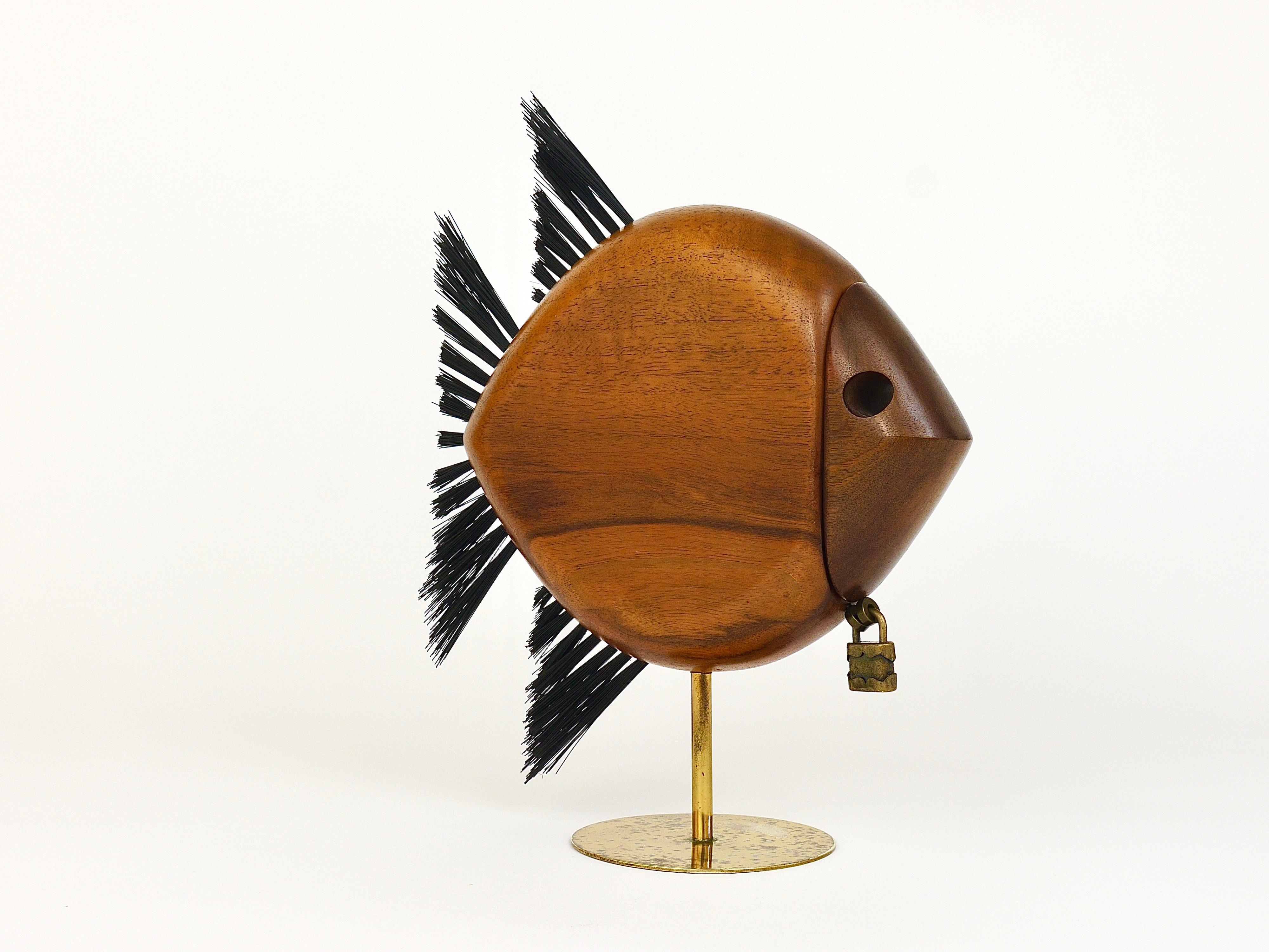A beautiful sculptural modernist piggy bank / money or savings box in the shape of a fish. Model No. 4946, designed and manufactured by Carl Auböck workshop in the 1960s in Austria. Original and old authentic vintage item, handmade of walnut wood,