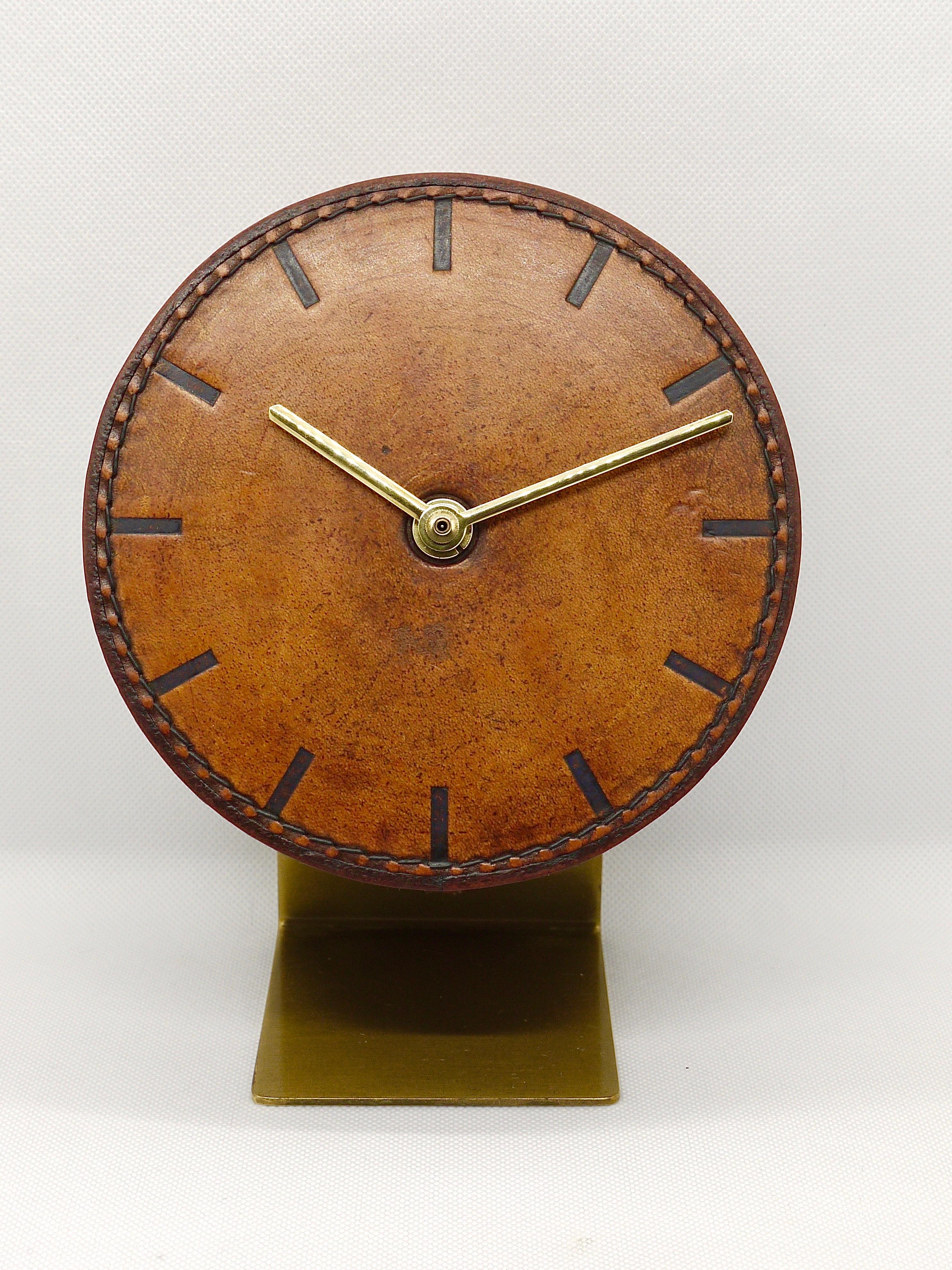 A beautiful leather and brass modernist clock from the 1950s, designed and executed by Carl Auböck, Vienna/Austria. An amazing straight-lined clock, has a leather covered clocks face and embossed marks for each hour. Battery-operated movement. Very