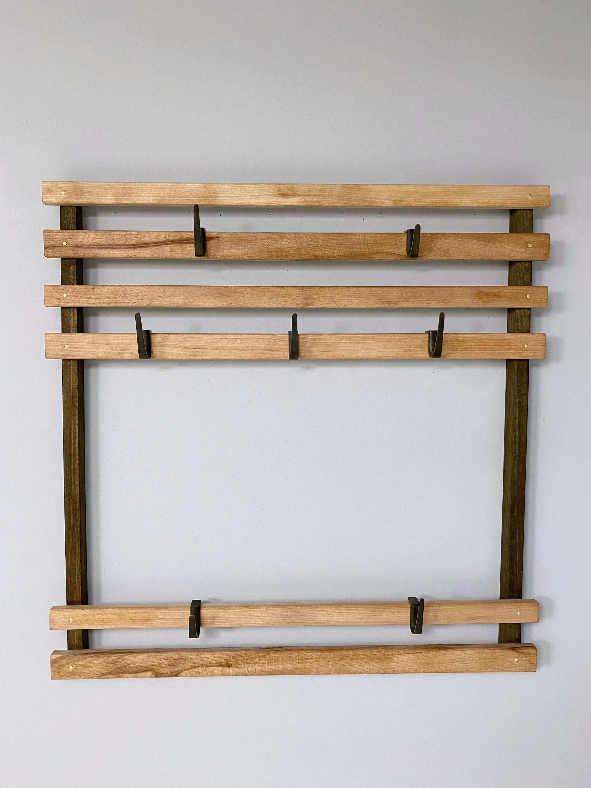 Austrian Mid-Century Modern coatrack #4547 made of solid waxed beech wood with seven patinated/polished solid brass hooks designed by Carl Auböck and handmade by Werkstätten Auböck.
Lit.: Carl Auböck the Workshop 1948 - 2005.

We ship with UPS &