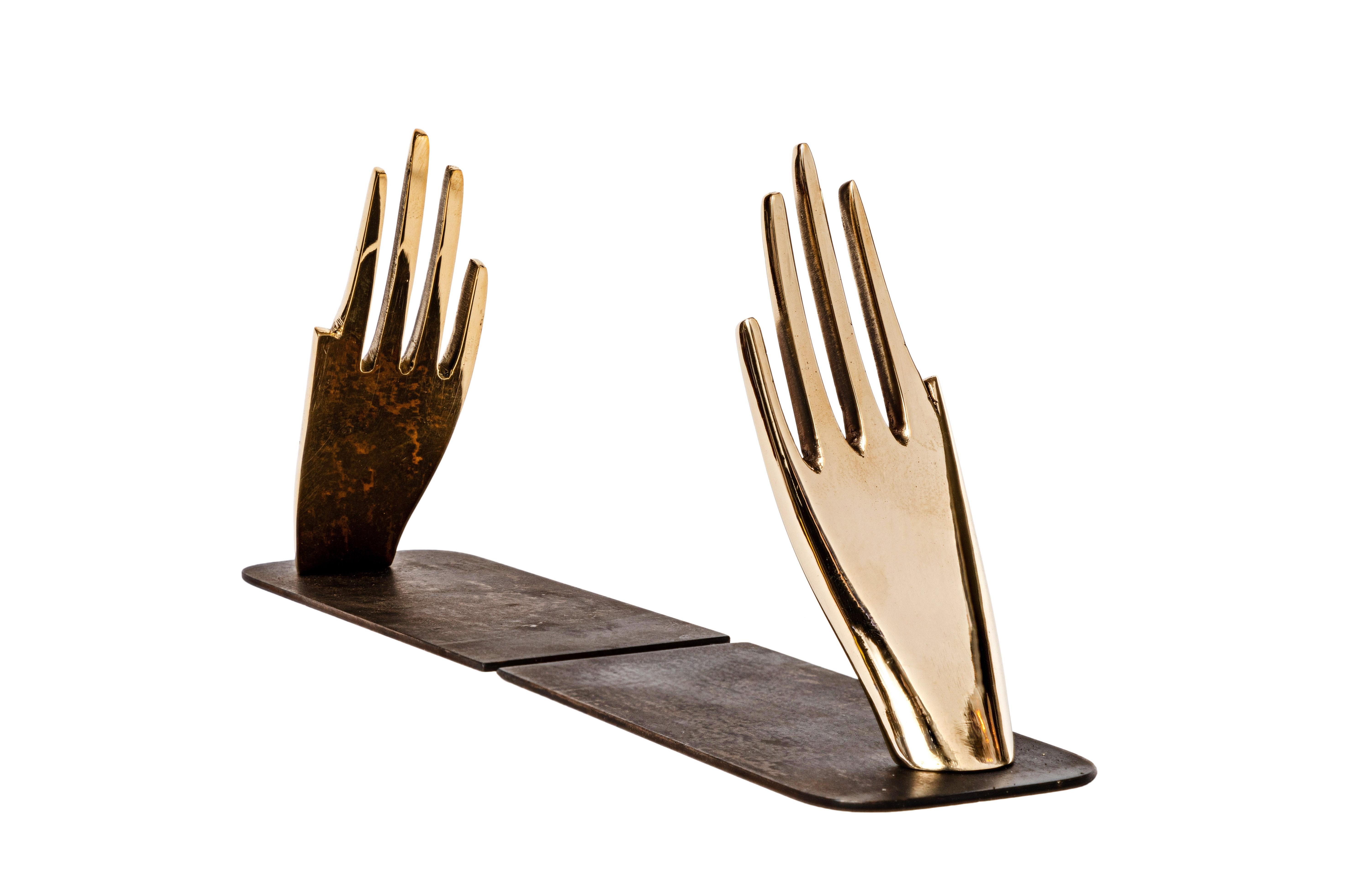 Pair of Carl Auböck model #1928 'Hands' brass bookends. Designed in the 1950s, this incredibly refined and sculptural pair of bookends are executed in patinated and polished brass.
Price is for the pair. One set in stock ready to ship. Available in