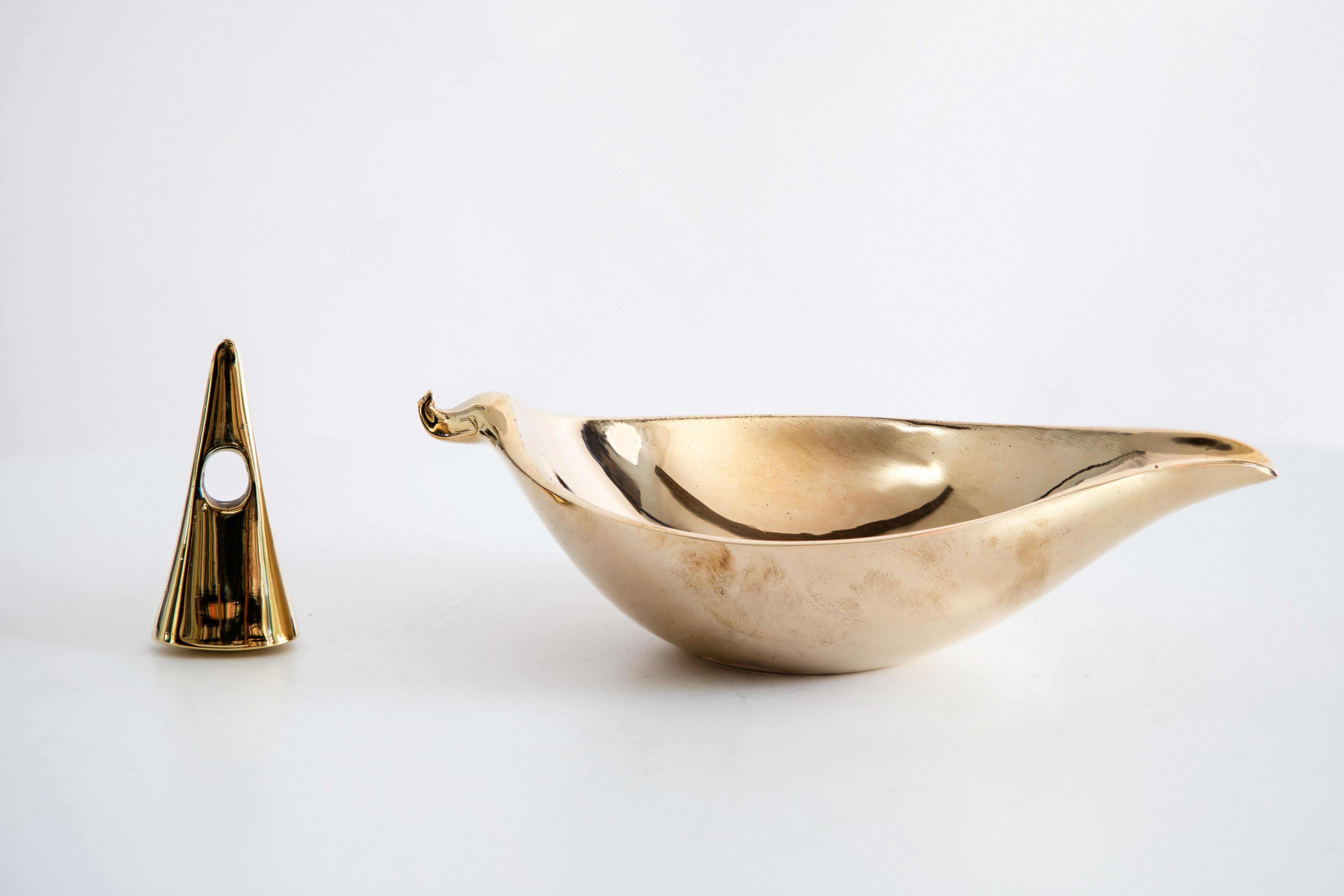 Carl Auböck model #3514 brass bowl. Designed in the 1950s, this incredibly refined and sculptural Viennese bowl is executed in polished brass. Originally conceived as an ashtray and snuffer, this decorative vessel can be used for a variety of