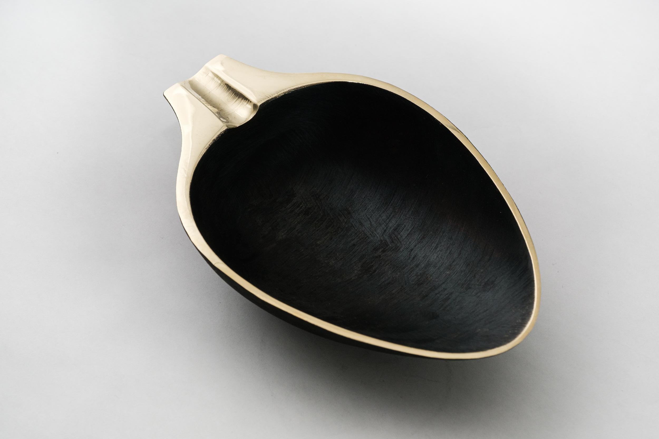 Carl Aubo¨ck Model #3548 patinated brass bowl. Designed in the 1950s, this incredibly refined and sculptural Viennese bowl is executed in polished and darkly patinated brass. Originally conceived as an ashtray, this decorative vessel can be used for