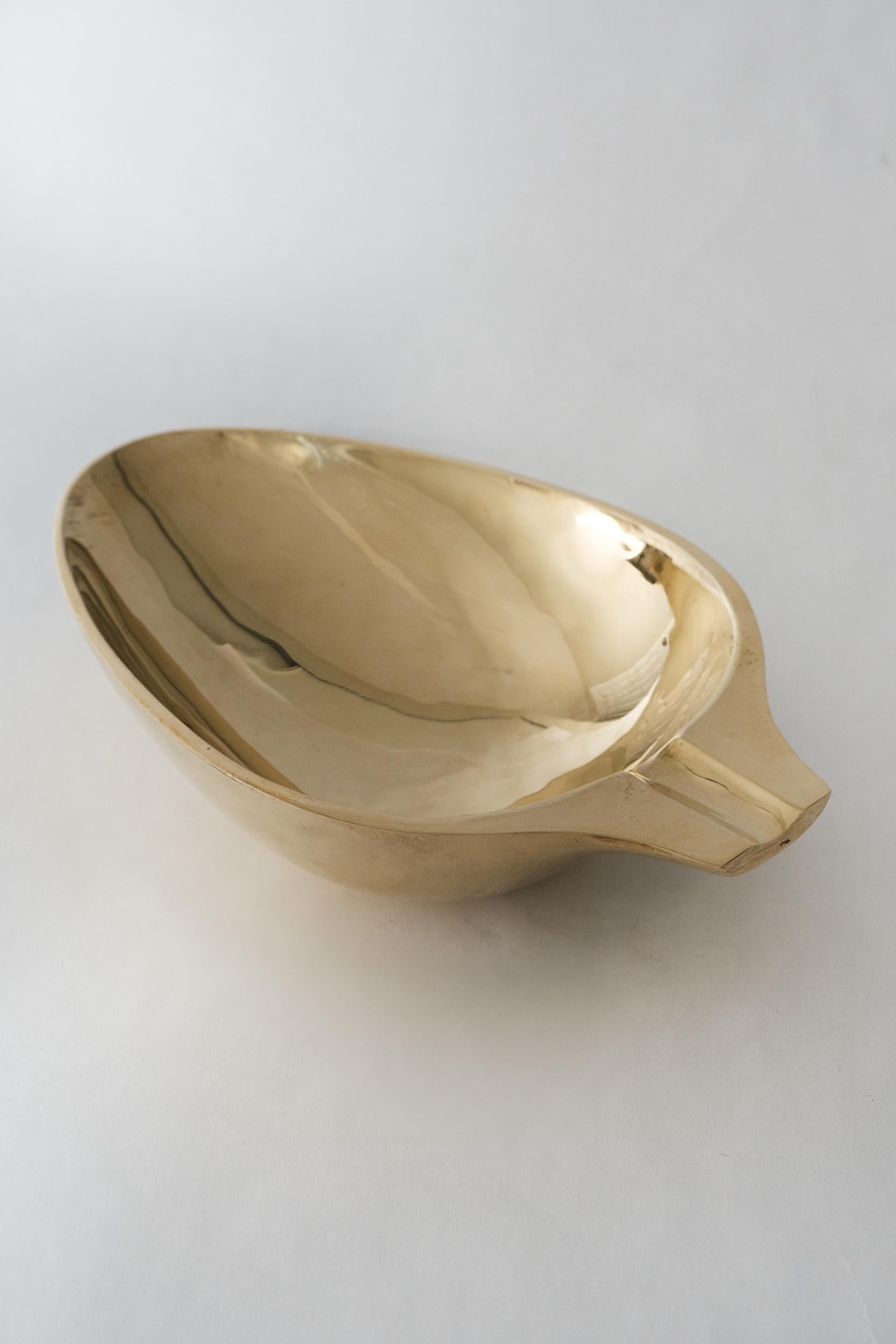 Carl Aubo¨ck Model #3548 polished brass bowl. Designed in the 1950s, this incredibly refined and sculptural Viennese bowl is executed in polished brass. Originally conceived as an ashtray, this decorative vessel can be used for a variety of
