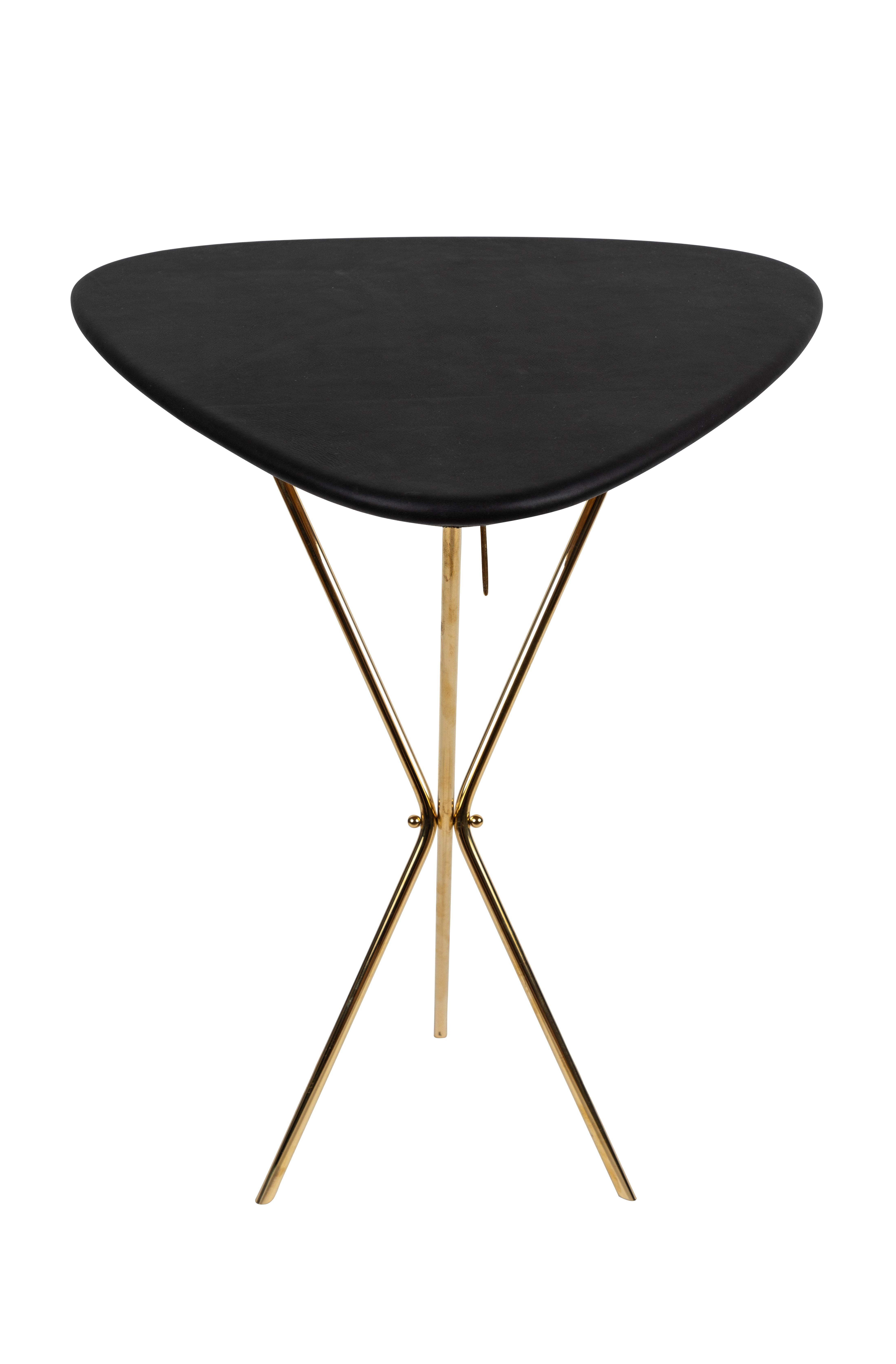 Carl Auböck model #3642 brass and leather table designed in the 1950s, this incredibly refined and sculptural table is executed in beautifully grained oak, polished brass and hand upholstered leather. Inspired by the folding map tables carried by