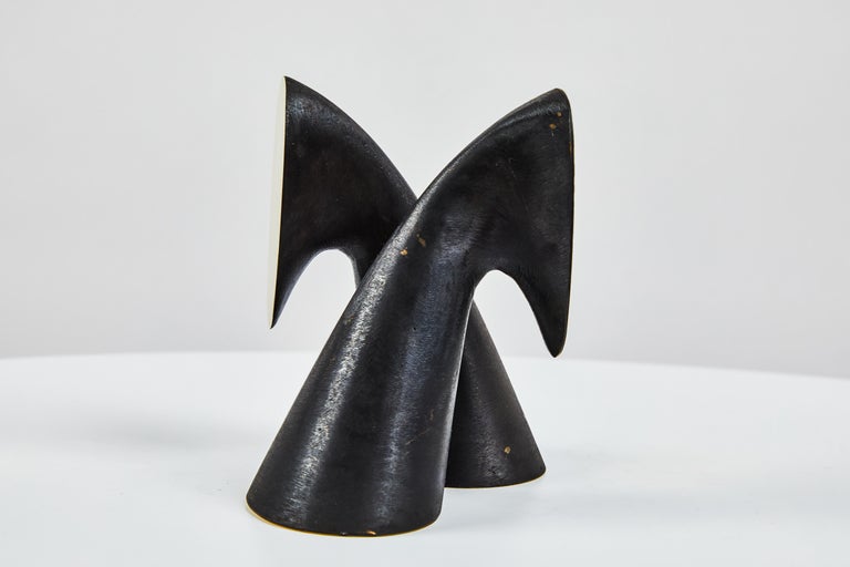 Pair of Carl Auböck model #3654 brass bookends. Designed in the 1950s, this incredibly refined and sculptural pair of bookends are executed in patinated and polished brass. 

Price is for the pair. 2 in stock. Out of stock lead time 2-3 weeks or