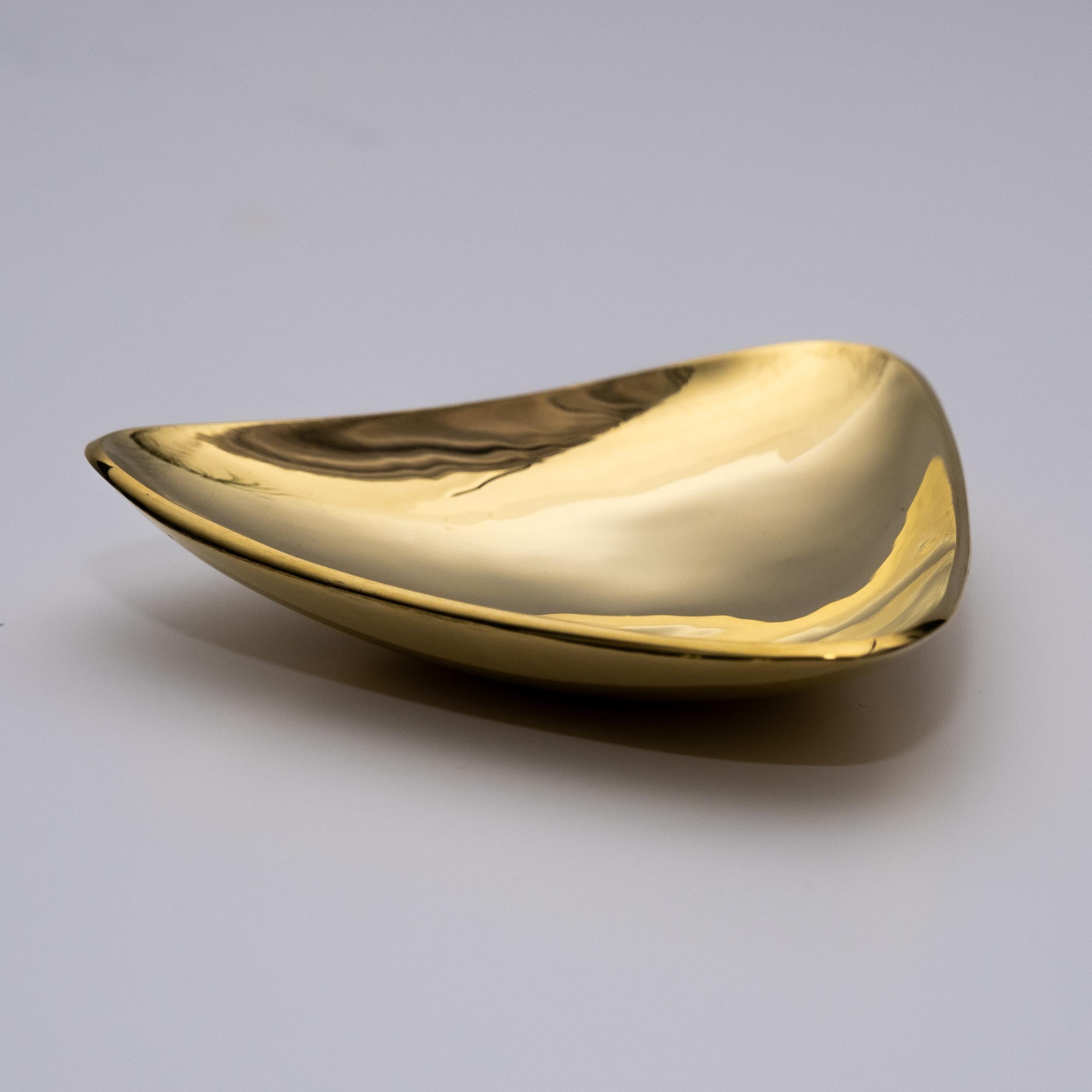 Carl Auböck model #3844 polished brass bowl. 

Designed in the 1950s, this incredibly refined and sculptural Viennese bowl or catch-all is executed in polished brass. Originally conceived as an ashtray, this decorative vessel can be used for a