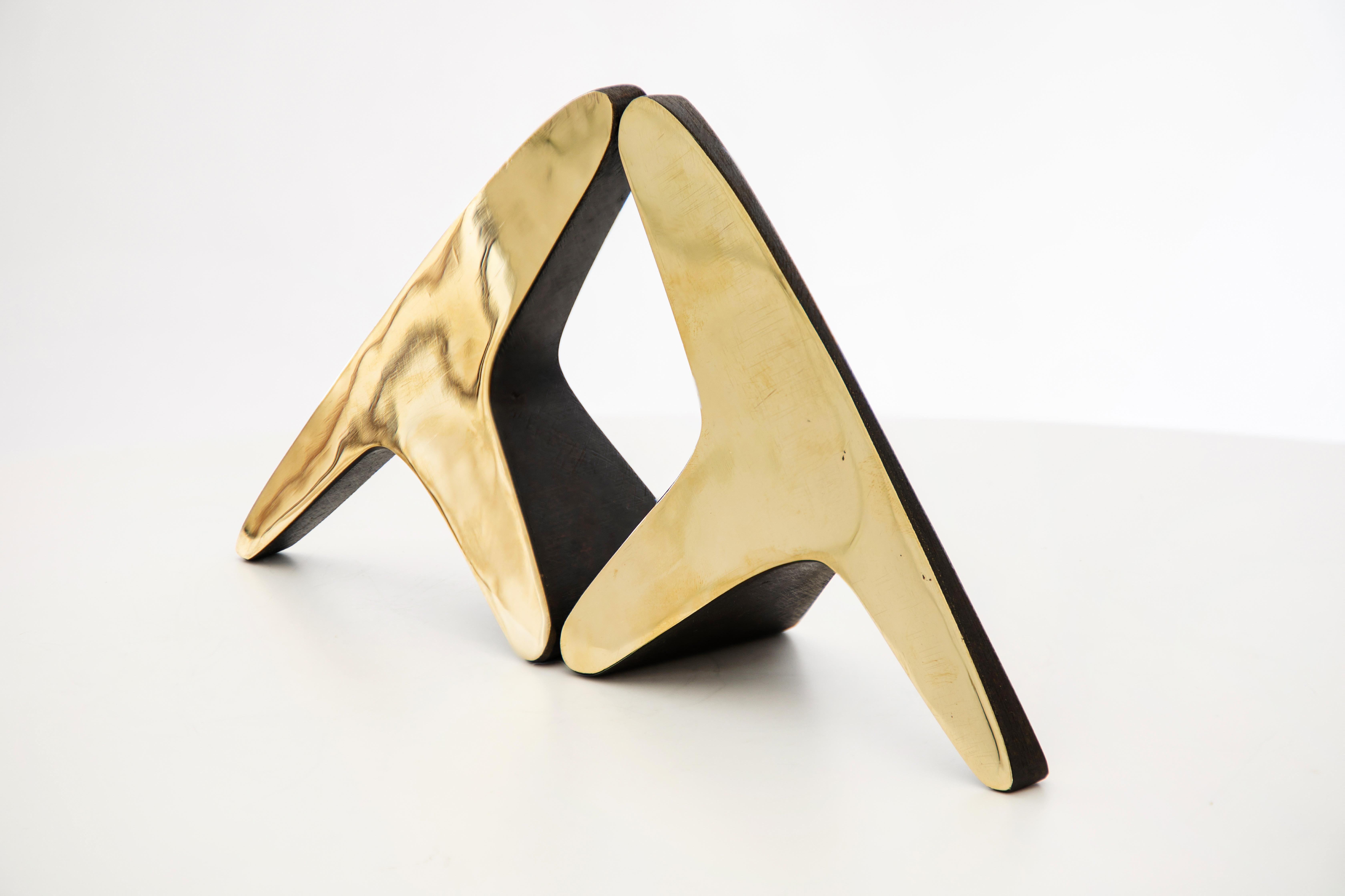 Pair of Carl Auböck Model #3847 brass bookends. Designed in the 1950s, this incredibly refined and sculptural pair of bookends are executed in polished and patinated brass. 

Price is for the pair. One pair in stock ready to ship. Available in