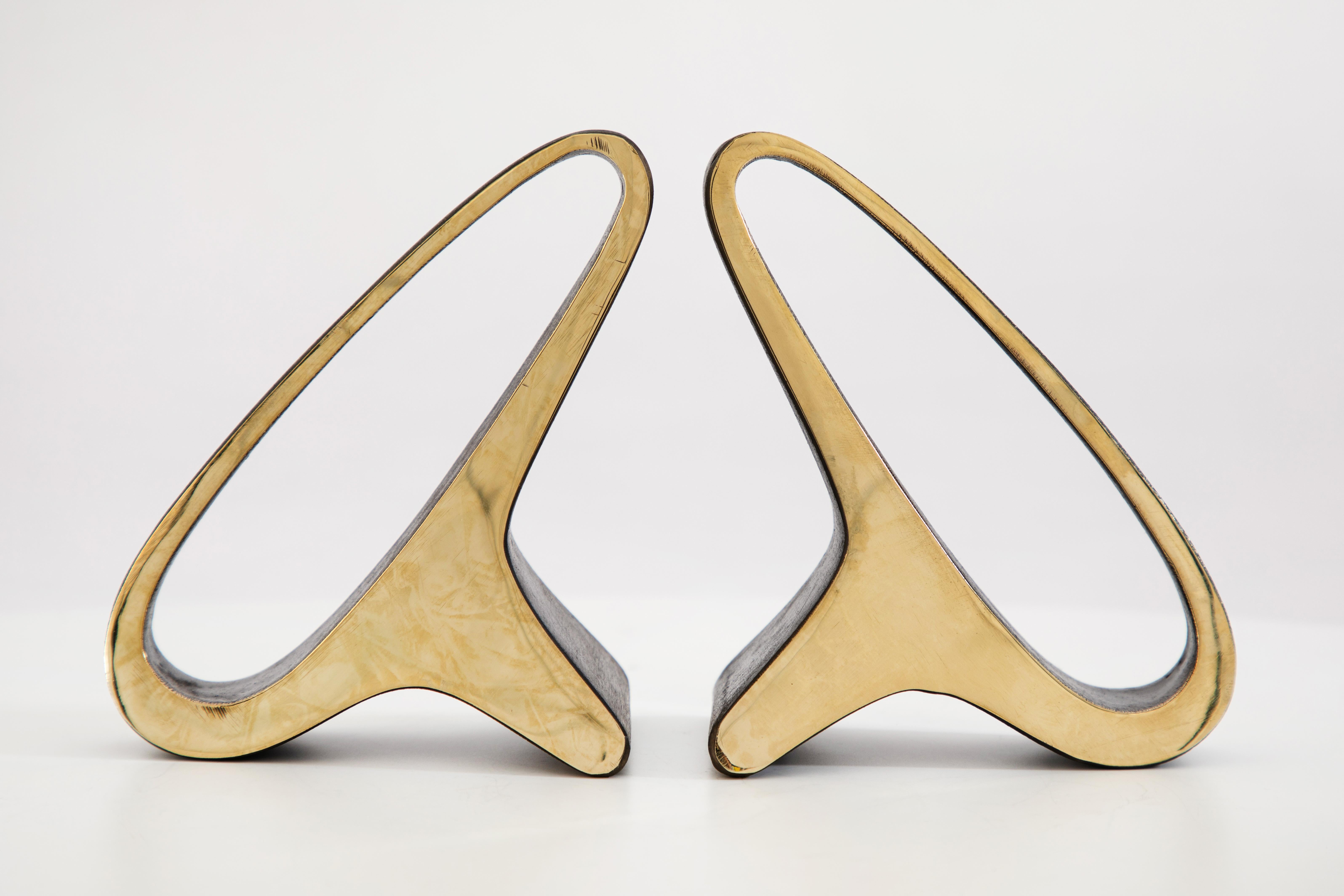 Pair of Carl Auböck model #3848 brass bookends. Designed in the 1950s, this incredibly refined and sculptural pair of bookends are executed in polished brass. 

Price is per pair. Available in unlimited quantities. Please note that in-stock