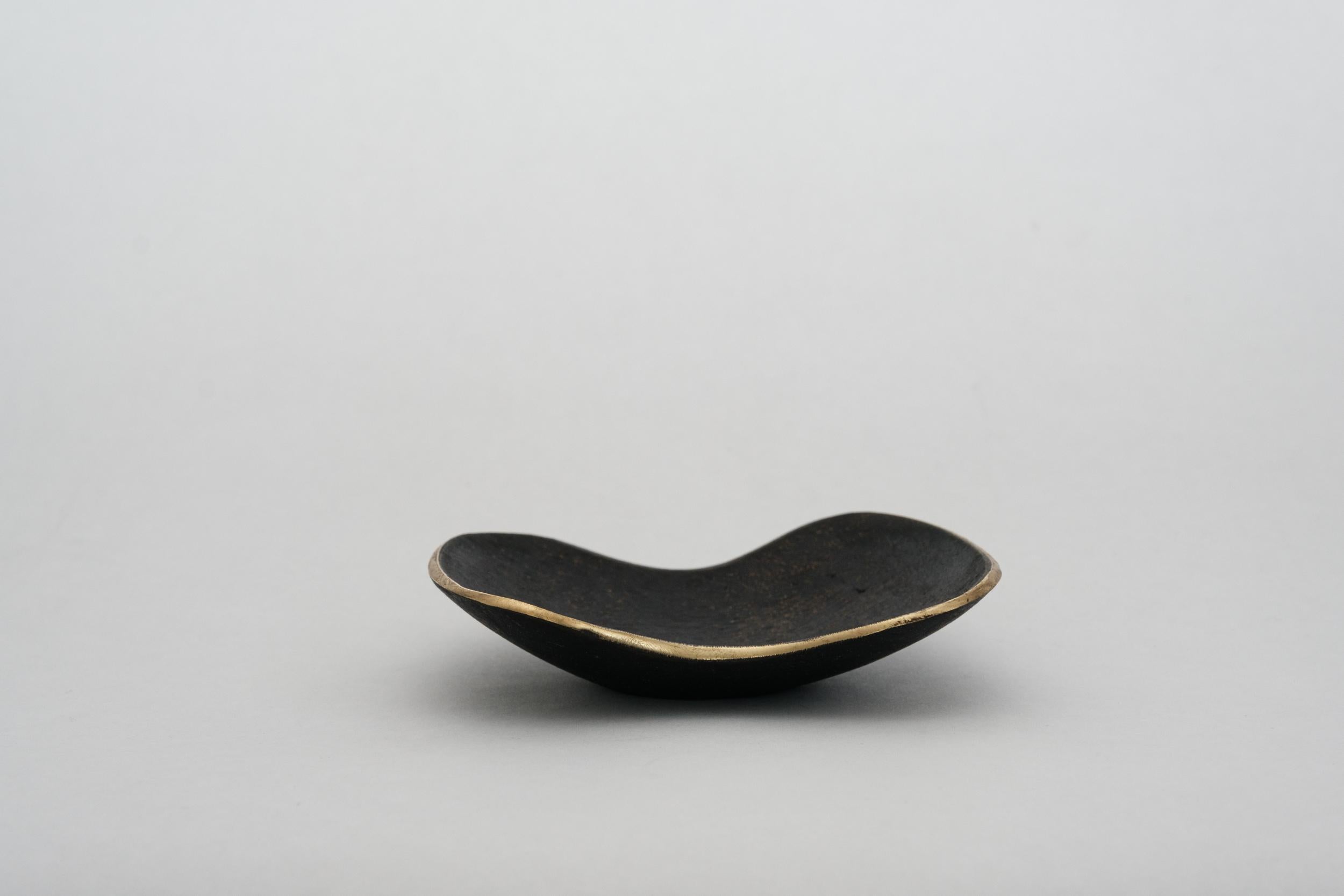 Carl Aubo¨ck Model #3979 patinated brass bowl. Designed in the 1950s, this incredibly refined and sculptural Viennese bowl is executed in polished and darkly patinated brass. Originally conceived as an ashtray, this decorative vessel can be used for