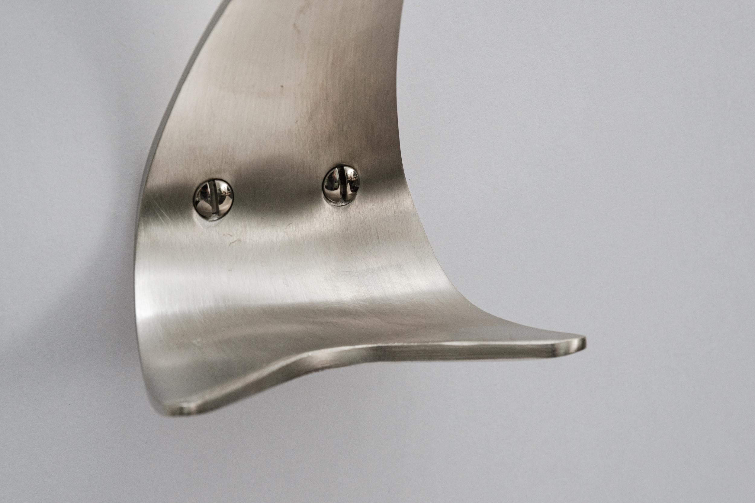 Carl Auböck Model #4086 nickel hook. Designed in the 1950s, this versatile and Minimalist Viennese hook is executed in brushed nickel by Werkstätte Carl Auböck, Austria. 

Produced by Carl Auböck IV in the original Auböck workshop in the 7th