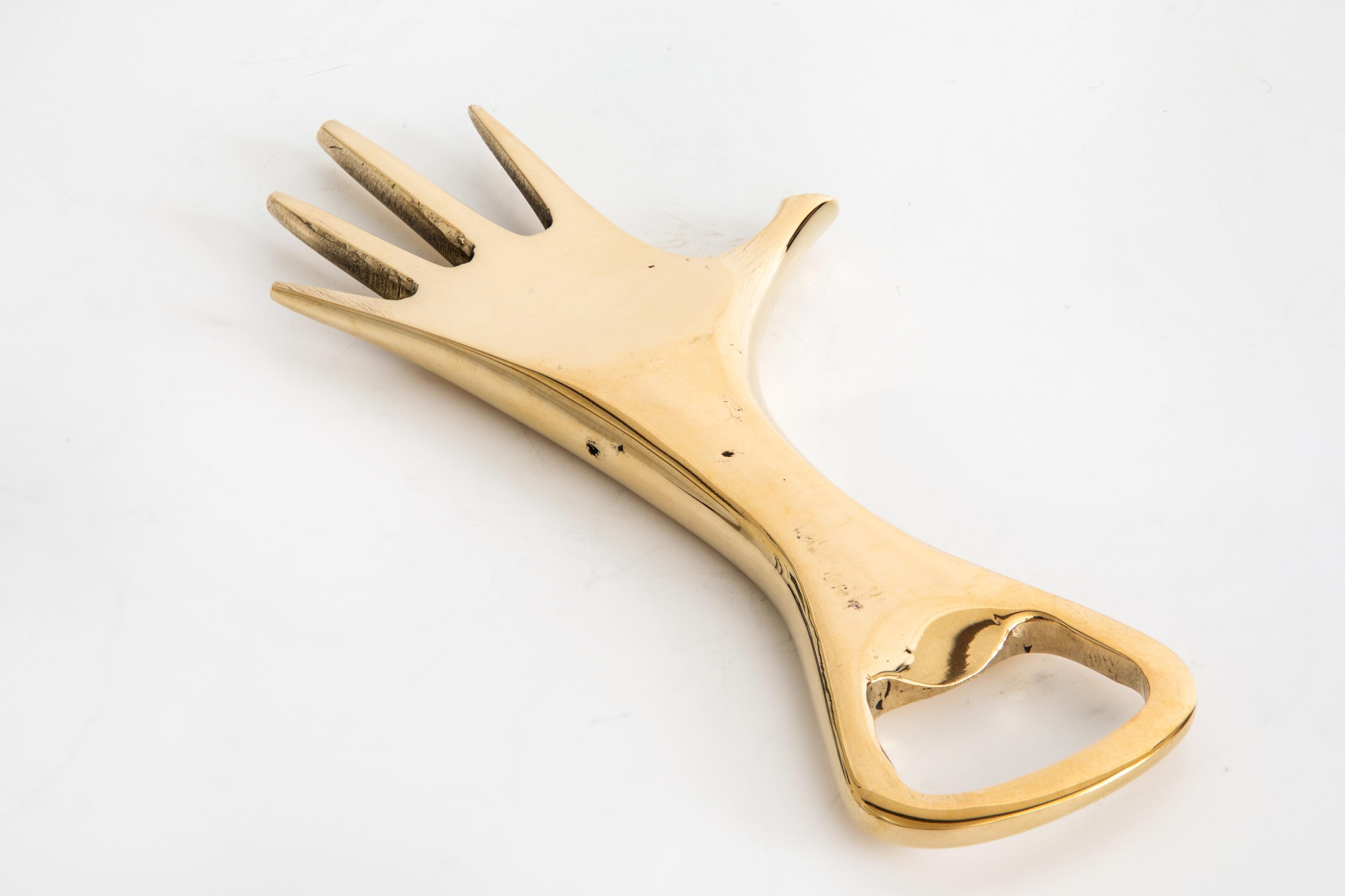 Carl Auböck Model #4224 'Hand' brass bottle opener. Designed in the 1950s, this incredibly refined and sculptural bottle opener is executed in polished brass. 

Price is per item. Three in stock ready to ship. Available in unlimited quantities. Out