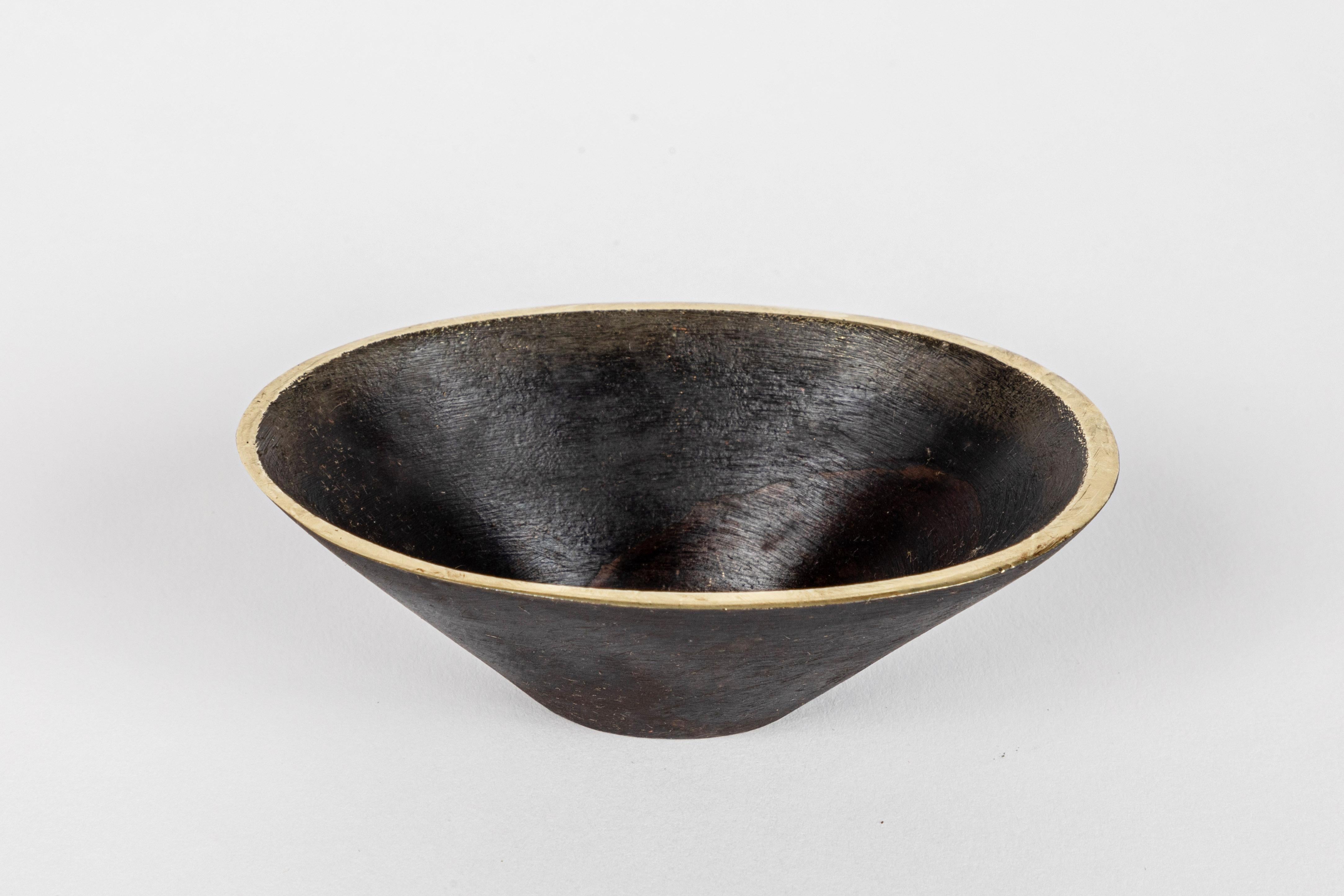 Carl Auböck model #4280 bowl in patinated brass. Designed in the 1950s, this incredibly refined and sculptural Viennese bowl is executed in patinated brass. Originally conceived as a petite bowl, this decorative vessel can be used for a variety of