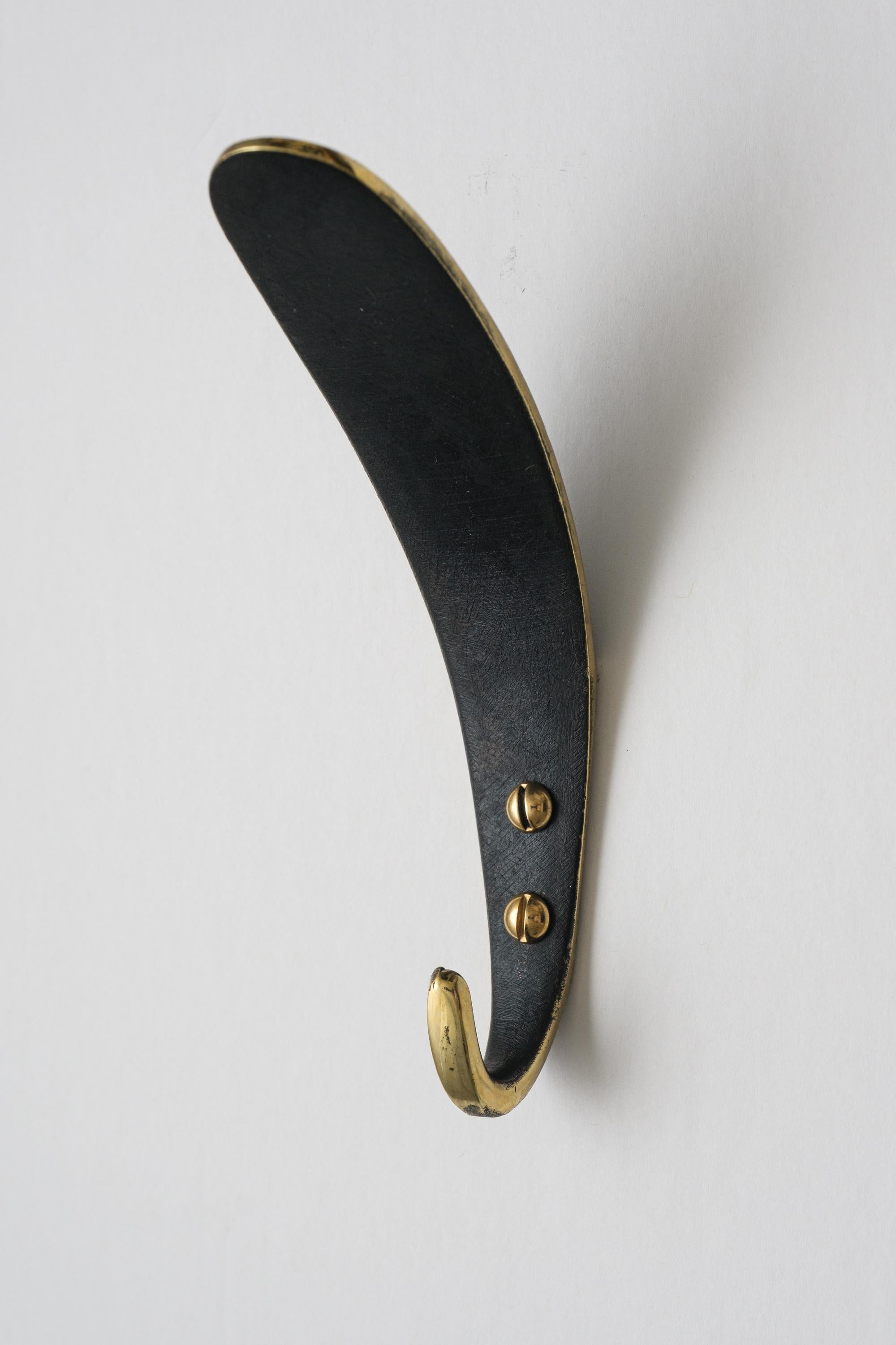Carl Auböck Model #4327 patinated brass hook. Designed in the 1950s, this versatile and minimalist Viennese hook is executed in patinated and polished brass by Werkstätte Carl Auböck, Austria.

Produced by Carl Auböck IV in the original Auböck