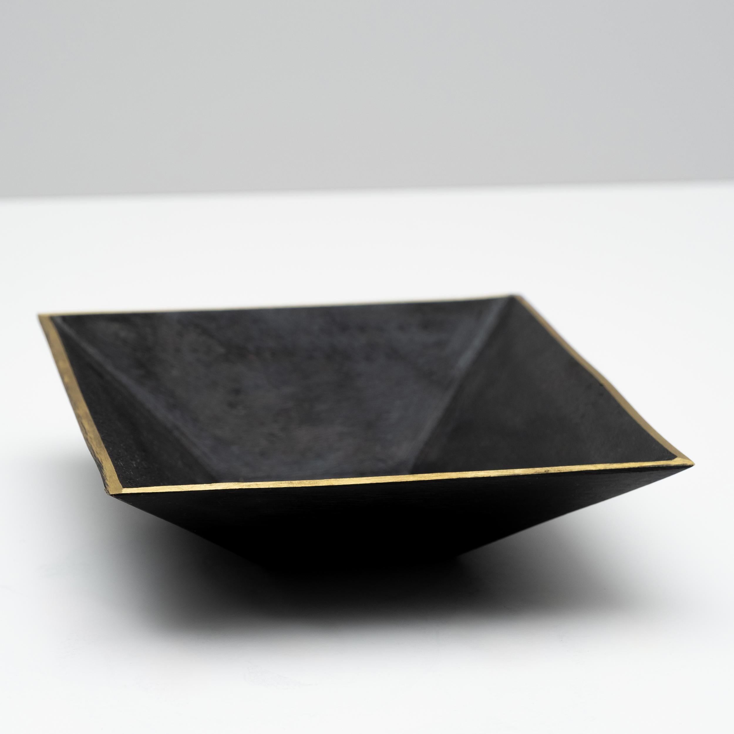 Carl Auböck Model #4482 patinated brass square dish. 

Designed in the 1950s, this incredibly refined and sculptural Viennese bowl is executed in polished and darkly patinated brass. Originally conceived as an ashtray, this decorative vessel can be