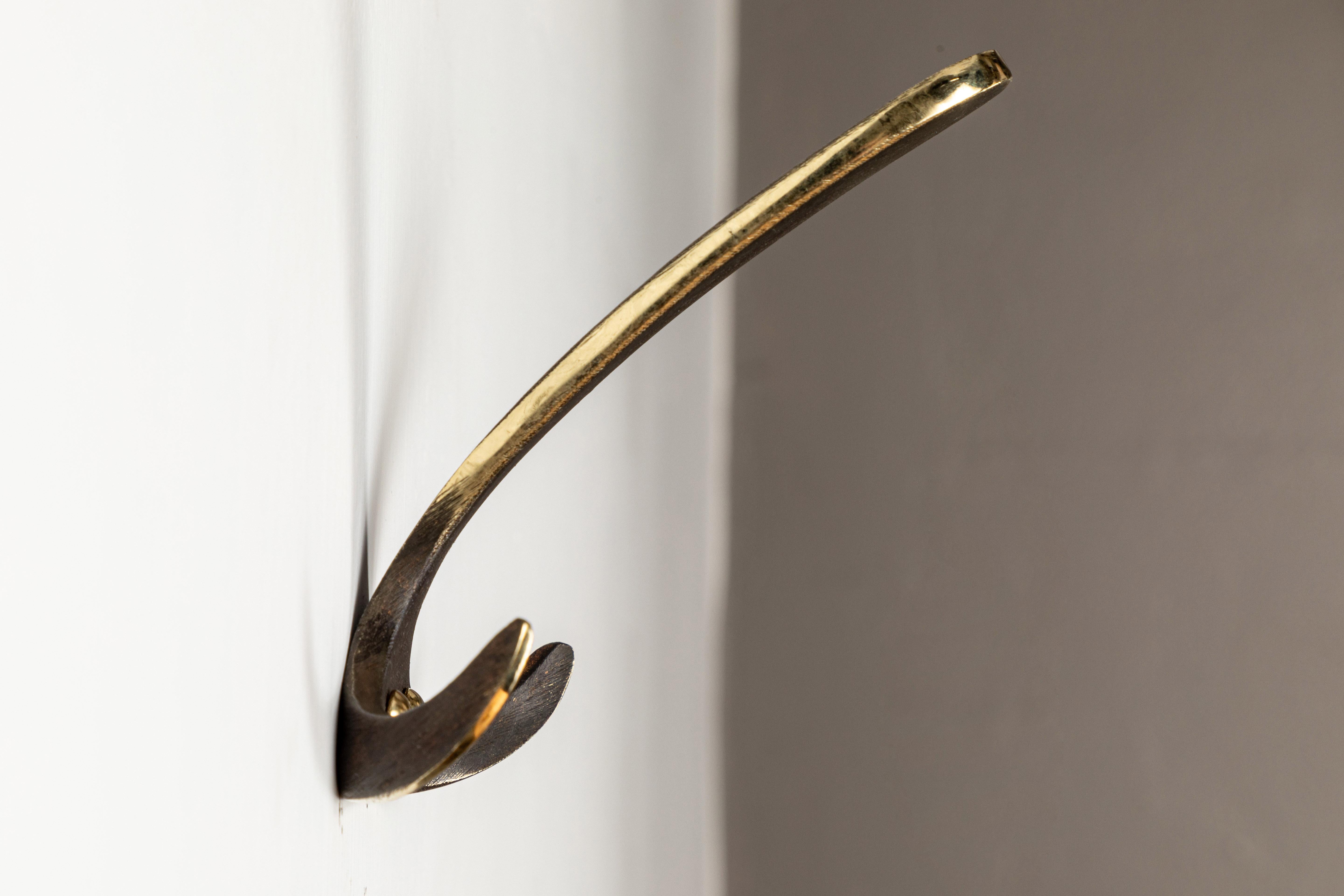 Carl Auböck model #4982 patinated brass hook. Designed in the 1950s, this versatile and minimalist Viennese hook is executed in patinated brass by Werkstätte Carl Auböck, Austria.

Produced by Carl Auböck IV in the original Auböck workshop in the