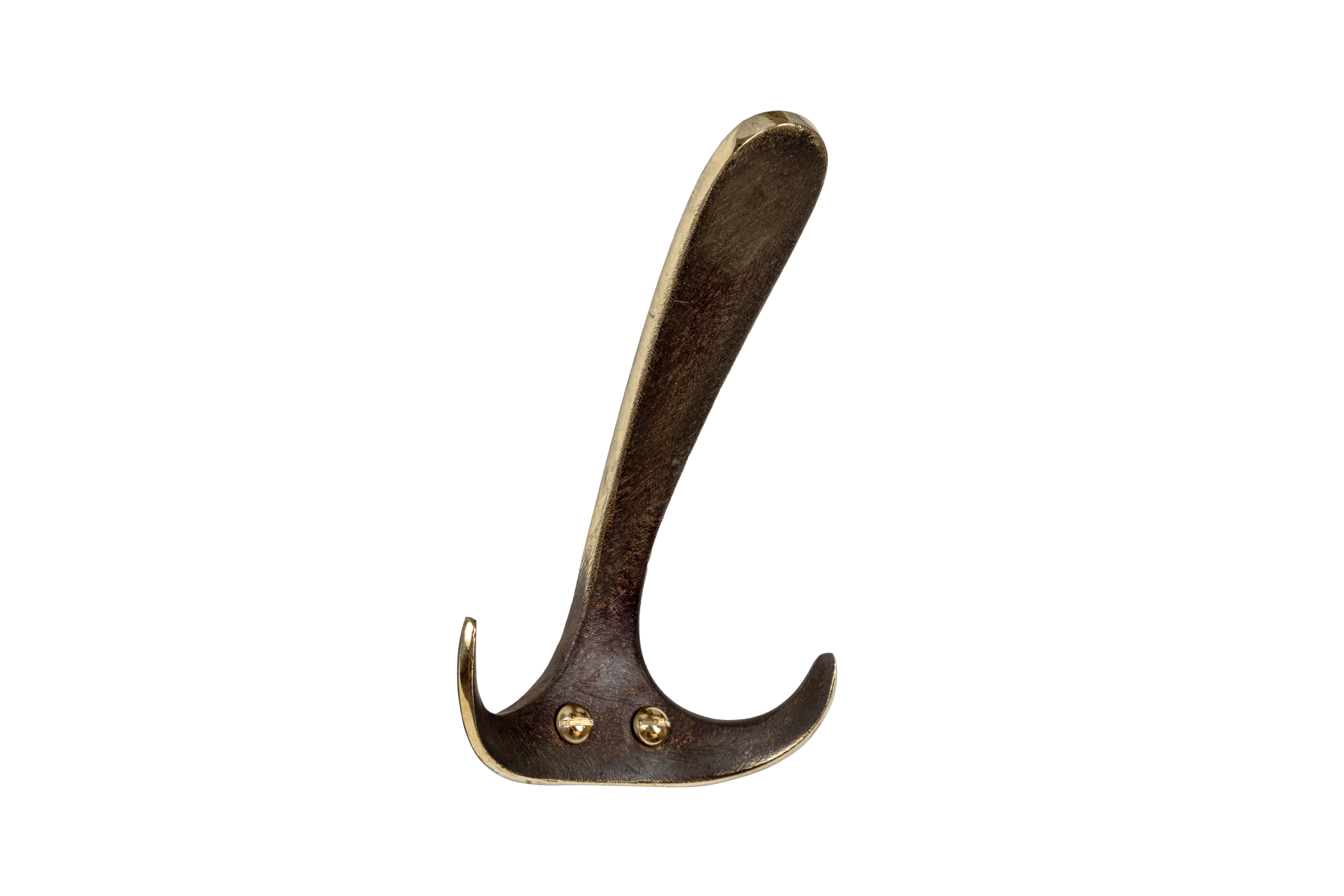 Carl Auböck model #4982 patinated brass hook. Designed in the 1950s, this versatile and minimalist Viennese hook is executed in patinated brass by Werkstätte Carl Auböck, Austria.

Produced by Carl Auböck IV in the original Auböck workshop in the