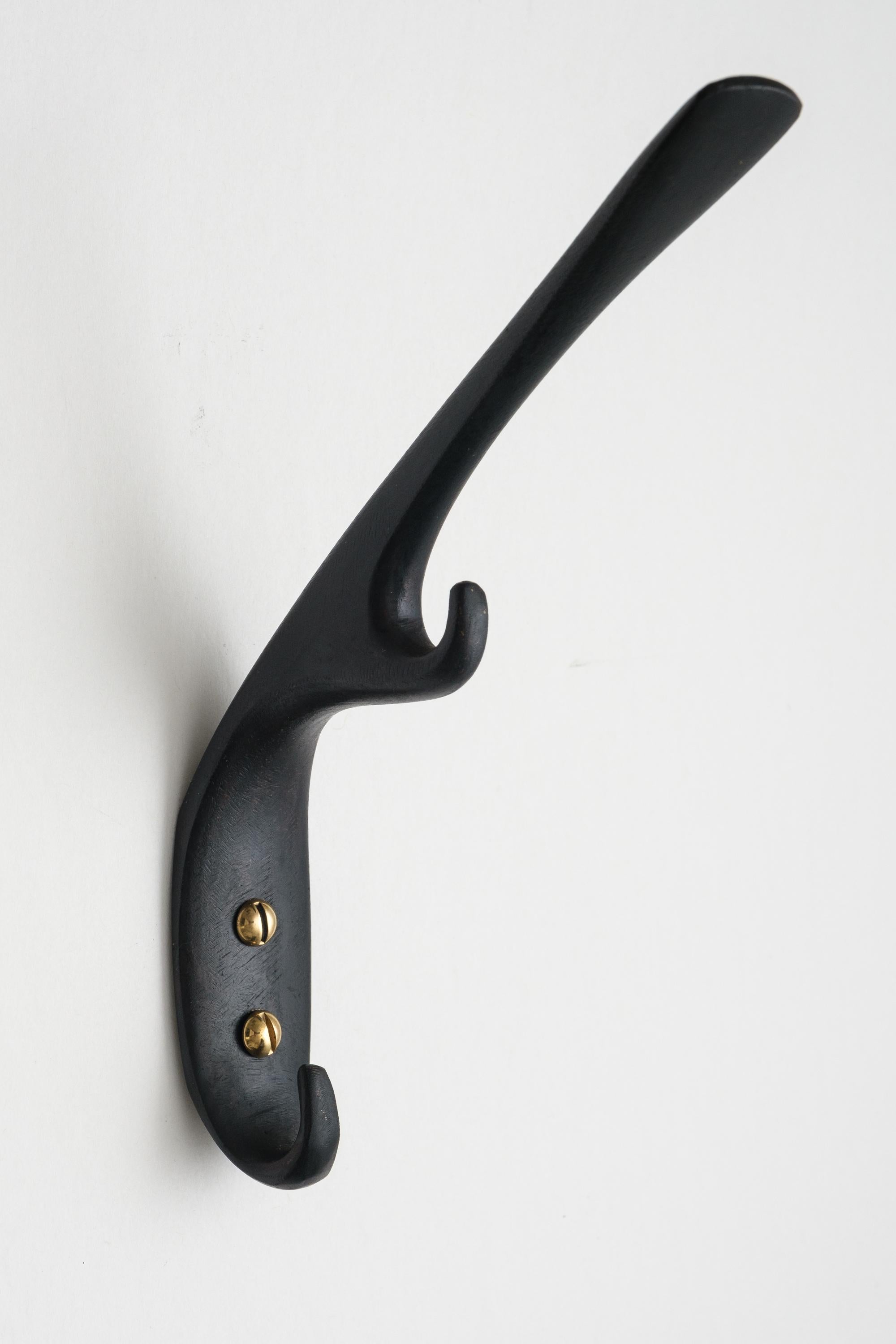 Carl Auböck #5439 patinated brass hook. Designed in the 1950s, this versatile and Minimalist Viennese hook is executed in darkly patinated and polished brass by Werkstätte Carl Auböck, Austria.

Produced by Carl Auböck IV in the original Auböck