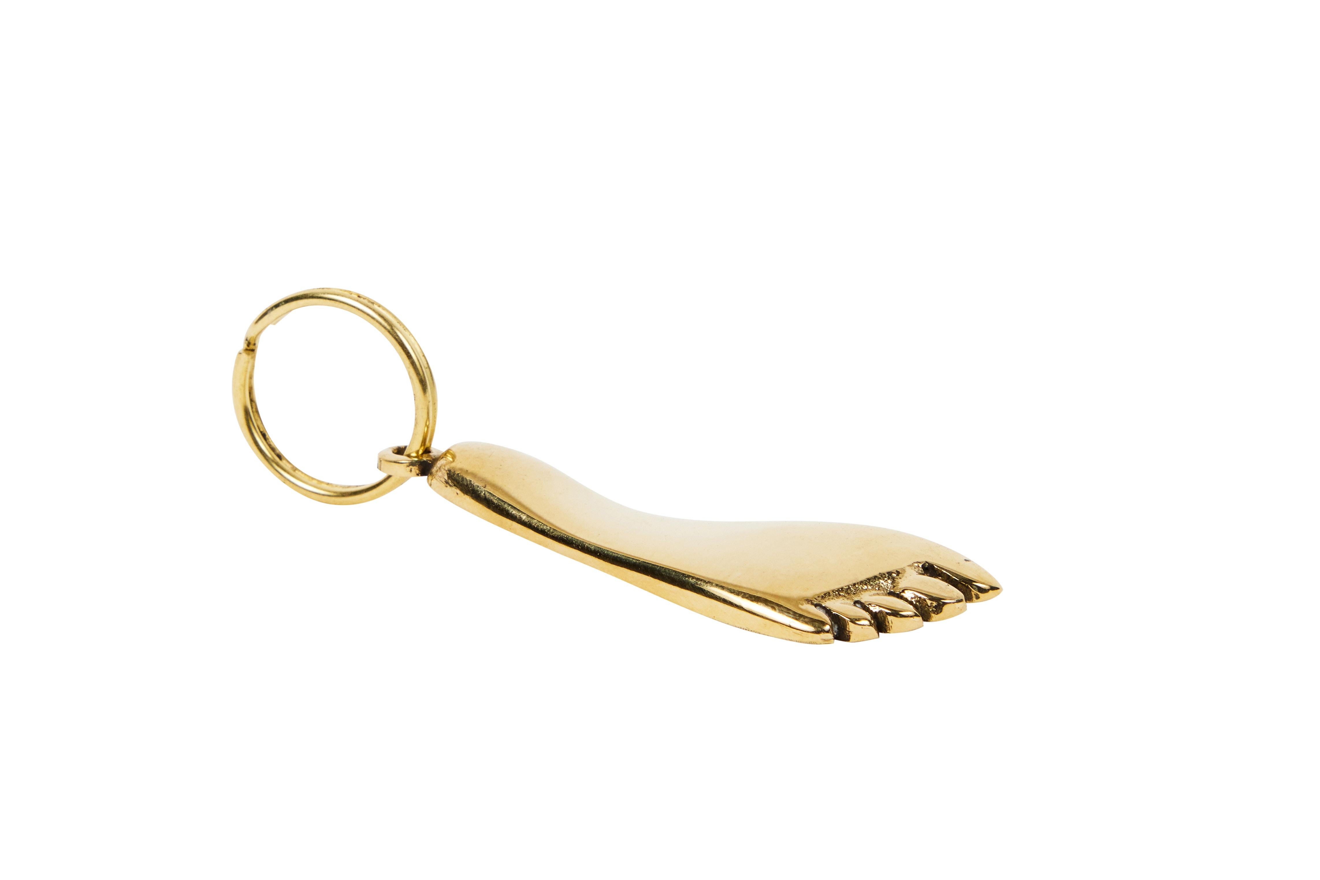 Carl Auböck model #5735 brass foot figurine keyring. Designed in the 1950s, this incredibly refined and sculptural object is hand fabricated in polished brass. 

Price is per item. One in stock ready to ship. Available in unlimited quantities.