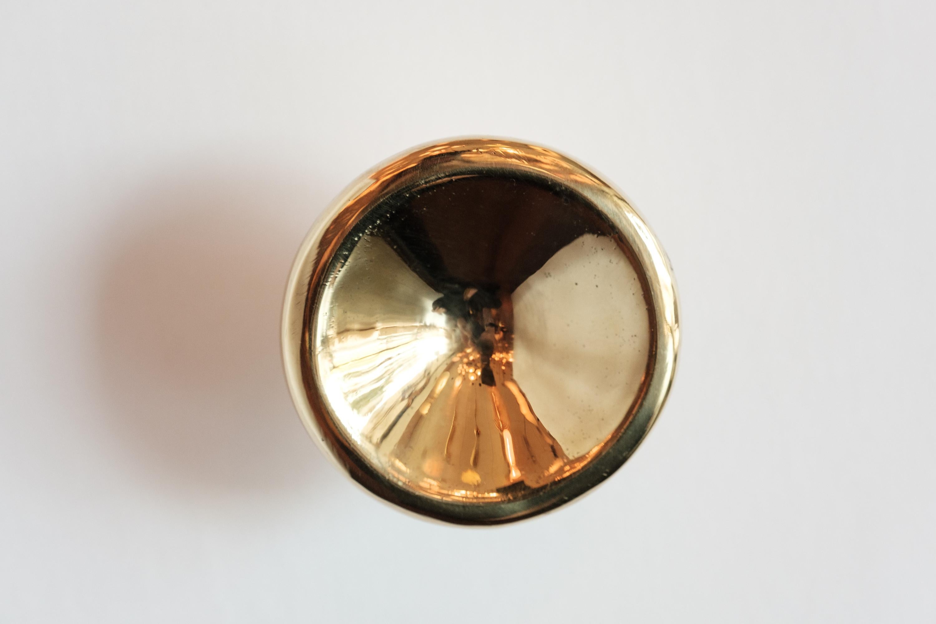 Carl Auböck Model #8040-1 polished brass knob.

Designed in the 1950s, this versatile and Minimalist Viennese knob is executed in polished brass by Werkstätte Carl Auböck, Austria. Its minimalist design combines clean form with