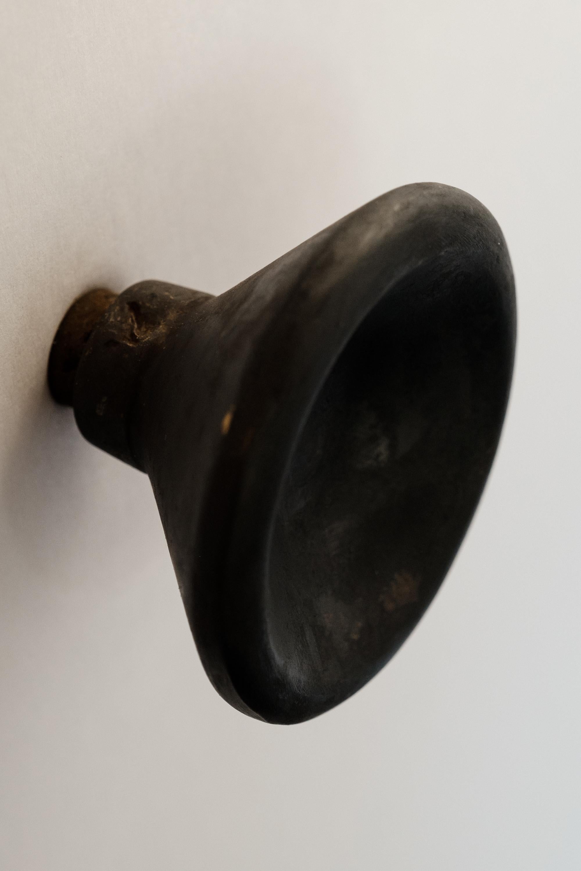 Carl Auböck Model #8040-2 patinated brass knob.

Designed in the 1950s, this versatile and Minimalist Viennese knob is executed in patinated brass by Werkstätte Carl Auböck, Austria. Its minimalist design combines clean form with