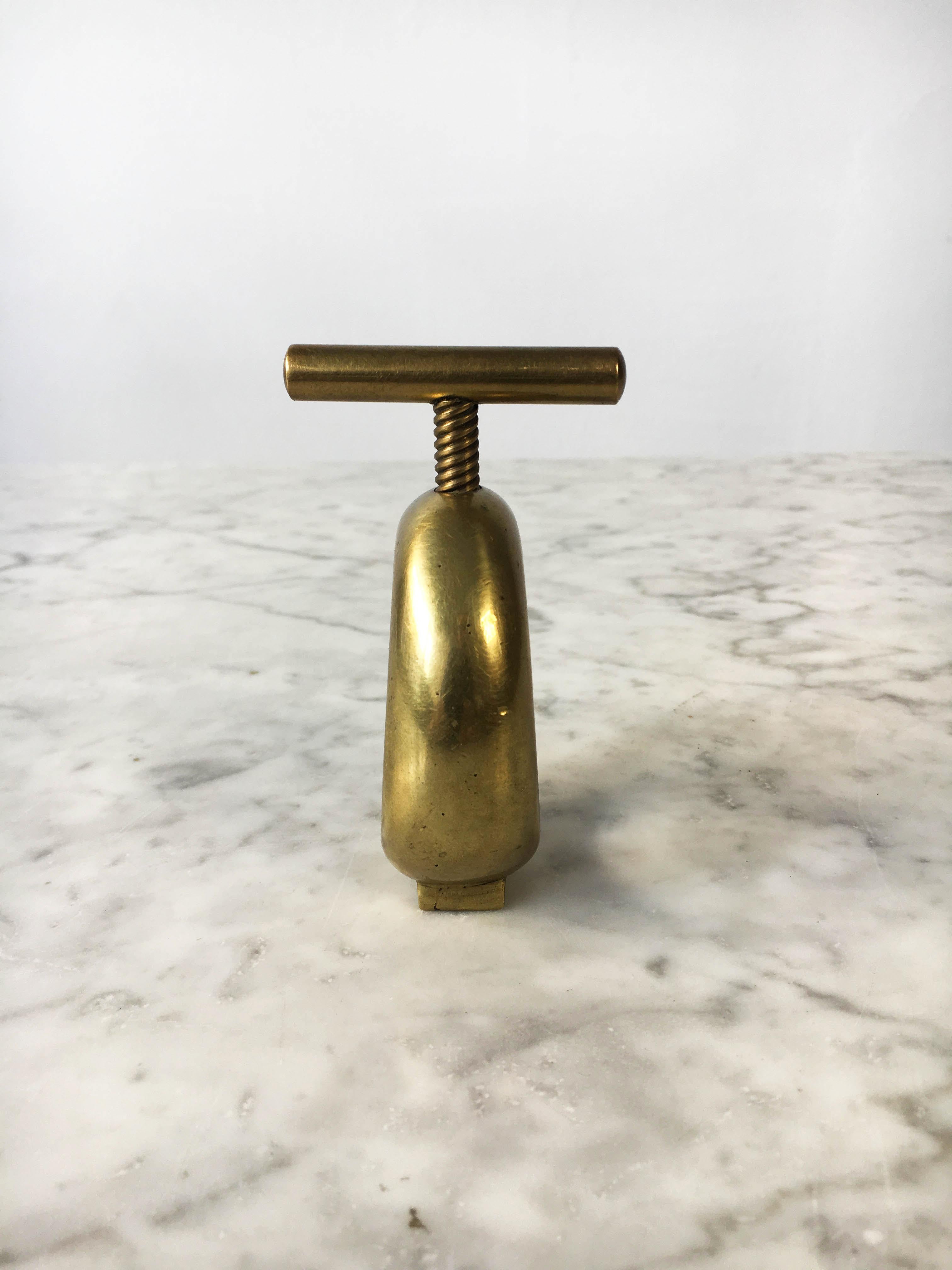 A beautiful modernist nutcracker and design object by Carl Auböck. In excellent vintage condition with just the right amount of gently aged patina on the brass and leather. Signed Auböck.
 