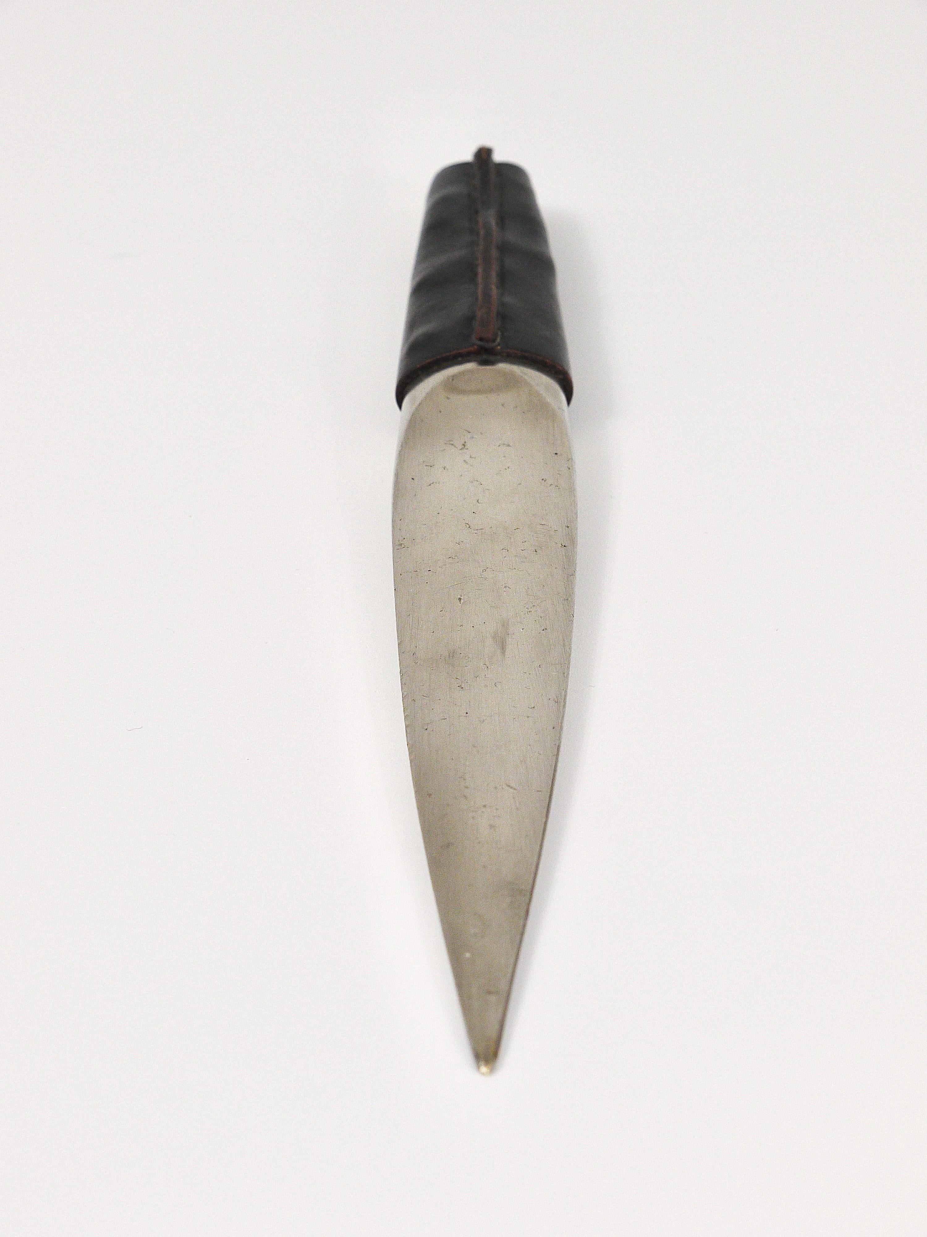 A beautiful and solid nickel-plated brass letter opener or paper knife with black leather handle from the 1950s, designed an executed by Carl Auböck, Vienna / Austria. Marked item in good condition with nice patina.