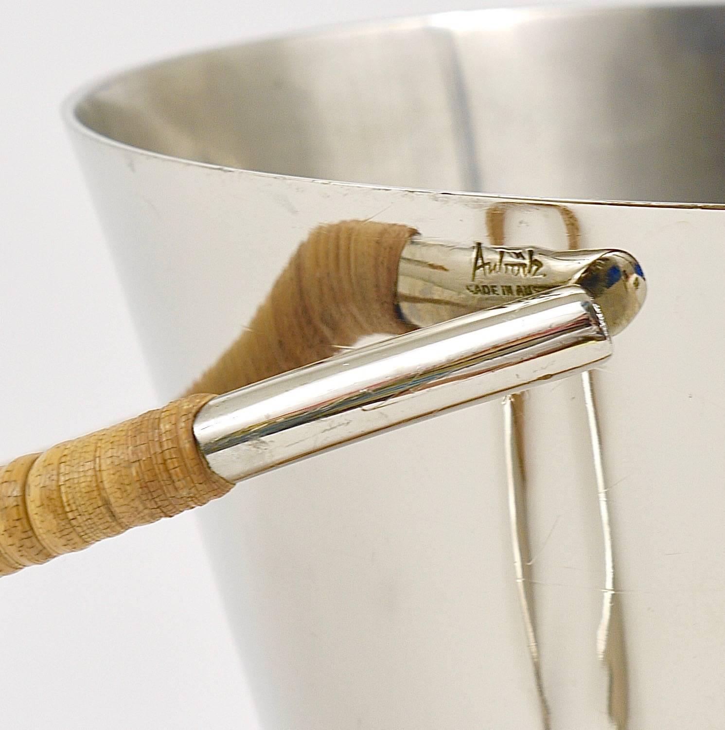 A beautiful Mid-Century Modern ice bucket and tongs, designed and executed by Carl Auböck, Vienna, in the 1950s. Made of nickel-plated brass with nice wicker on its handle and bottom. In excellent condition, marked piece. Measures: Height with