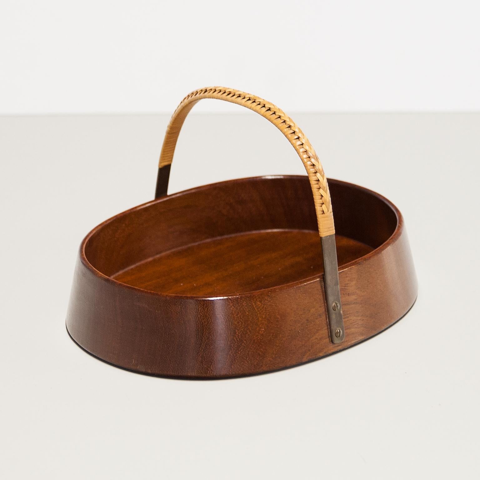 Original Carl Auböck nut bowl element made by of solid teak wood and brass loop with leather at the top for carrying. This fantastic piece was designed by Carl Auböck in the 1950s, and handcrafted in his Workshop in Vienna, Austria. The item still