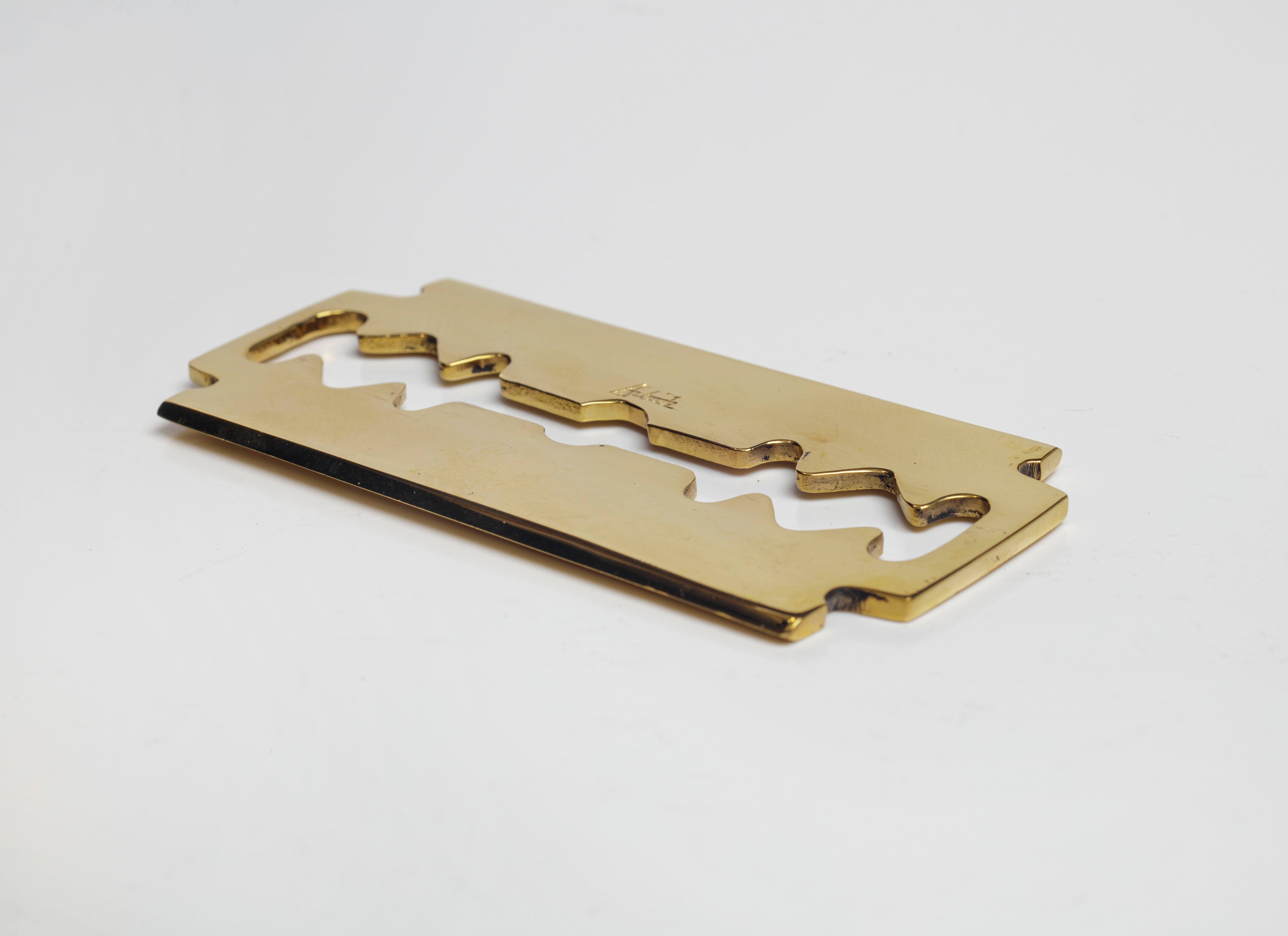 Brass paperweight #5378-1 in the shape of a razor blade by Carl Auböck, New.