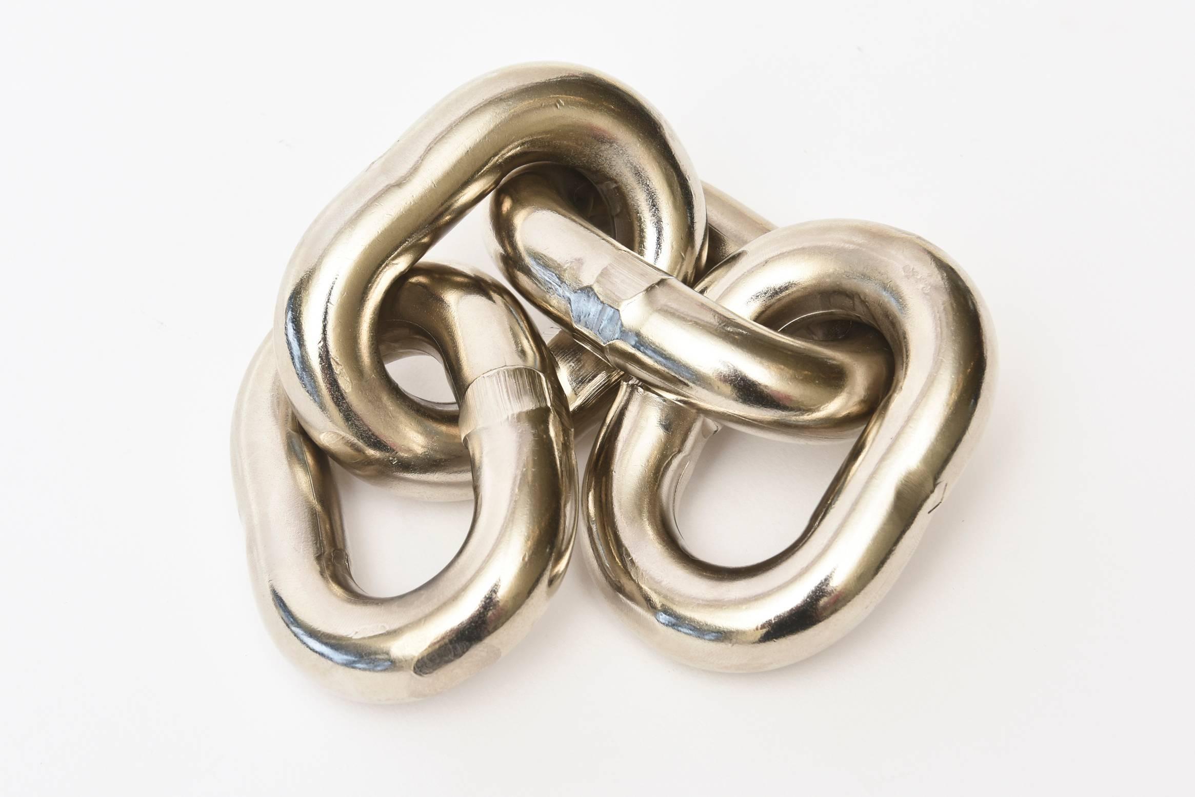 This heavy four-chain link paperweight sculpture/desk accessory by the renowned Viennese Carl Aubock is silvered bronze. This was done in the late 1960s. This inspiration came from a wartime ritual at sea.
Carl Aubock who lived from 1900-1957