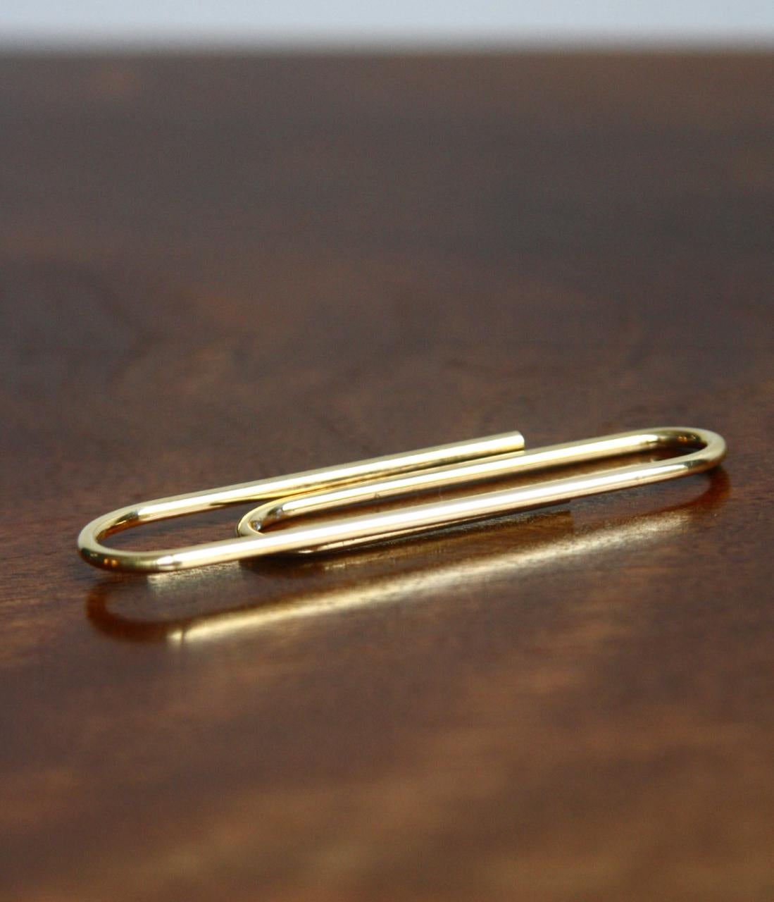 Description:
A small solid, polished brass paper clip designed by Auböck II circa 1950 but made today by Carl Auböck IV. Designed to keep documents in order, the clip is formed of a continuous thick gauge brass wire. Stamped with the Auböck
