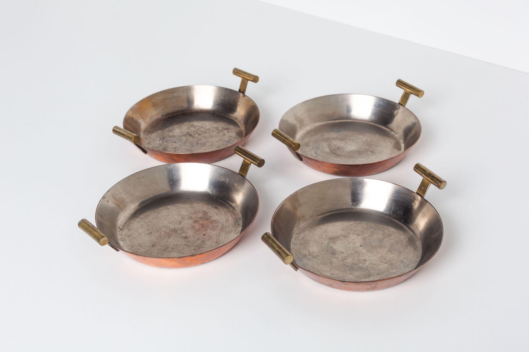 Carl Aubock Steel and Copper Egg Pans, Set of Four, Model 4301
Cast brass handles stamped 'Auböck MADE IN AUSTRIA'