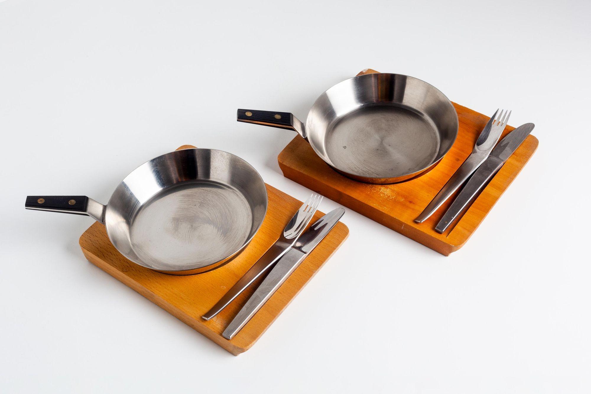 Carl Aubock Tableware Service Tray and Skillet for Two with Amboss 2060 Flatware. Each set has a stainless steel skillet, wooden handle, wood block tray, Amboss 2060 small forks and knives. Model no. 200, designed by Carl Auböck in the 1950s,