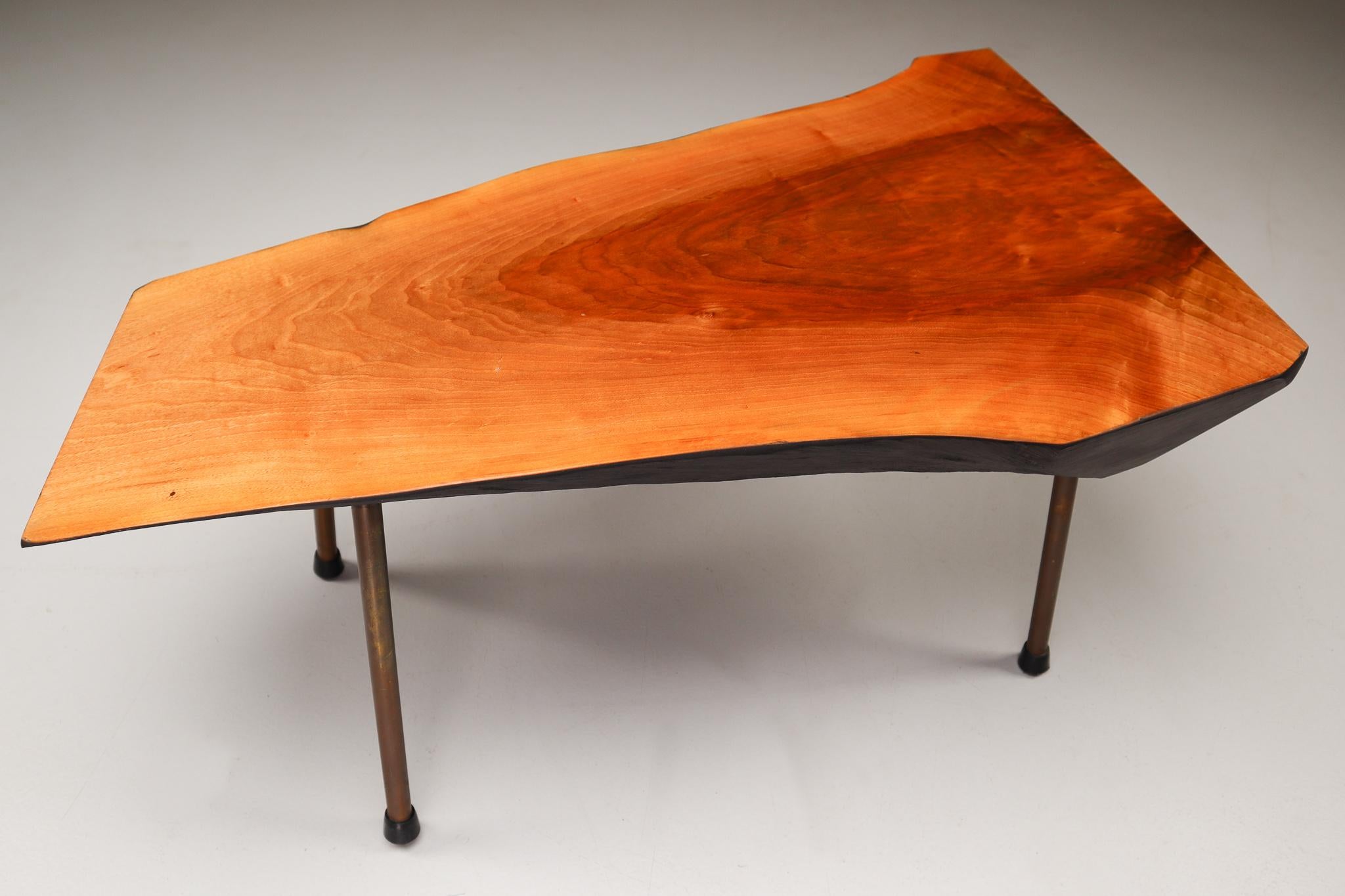 A walnut tree trunk coffee table by Austrian designer Carl Auböck II (often simply referred to as Carl Auböck), from circa 1950s. A large tree trunk table designed and made by the Auböck Werkstätte, circa 1950s. The modernist table is made of