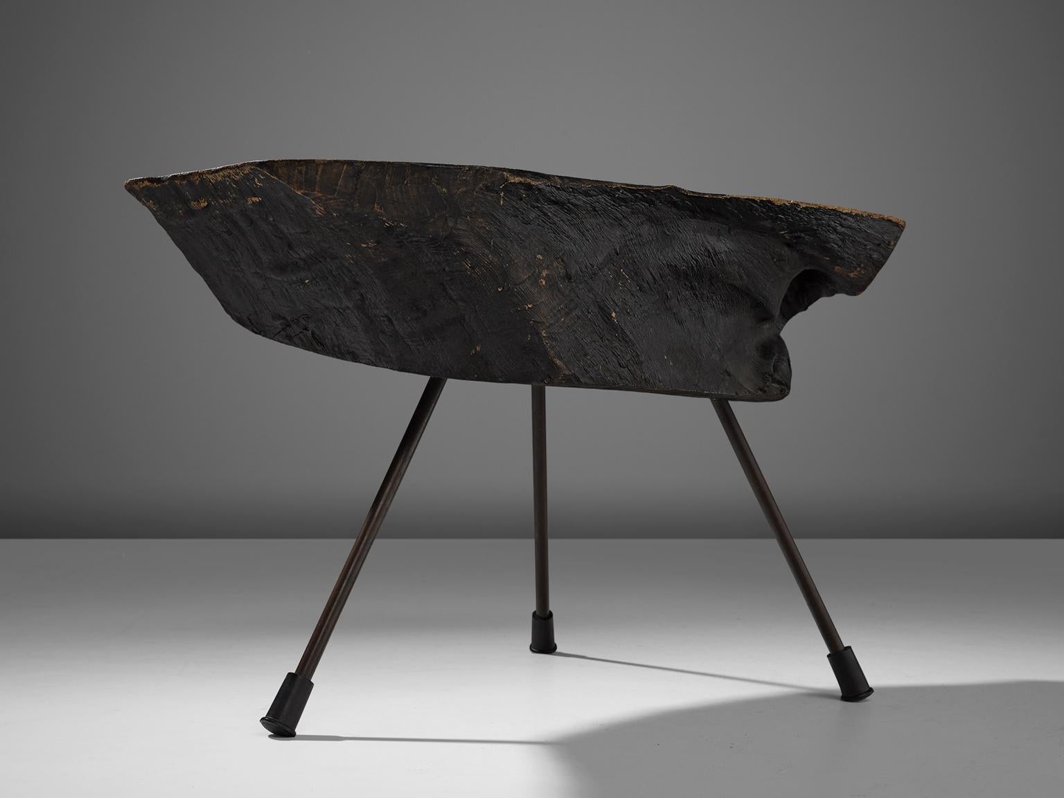 Carl Auböck, tree trunk coffee table in walnut and brass, Austria, circa 1950. 

This unique piece is designed by Carl Auböck II. The color and movement in the grain of this piece of walnut showcase the history and beauty of the material. The