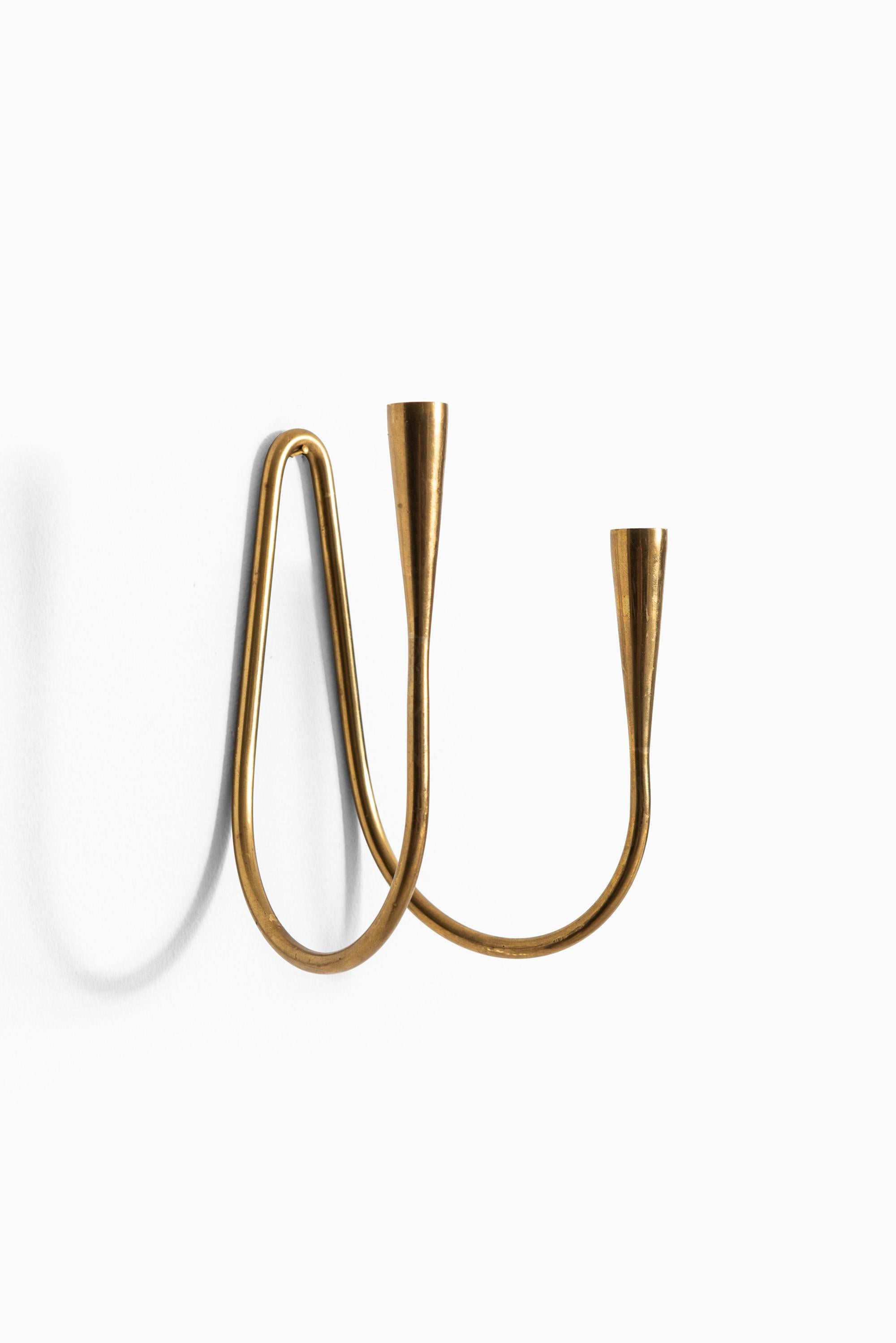 Wall hanged candlesticks in brass. Produced by Illum Bolighus in Denmark. Pair available.