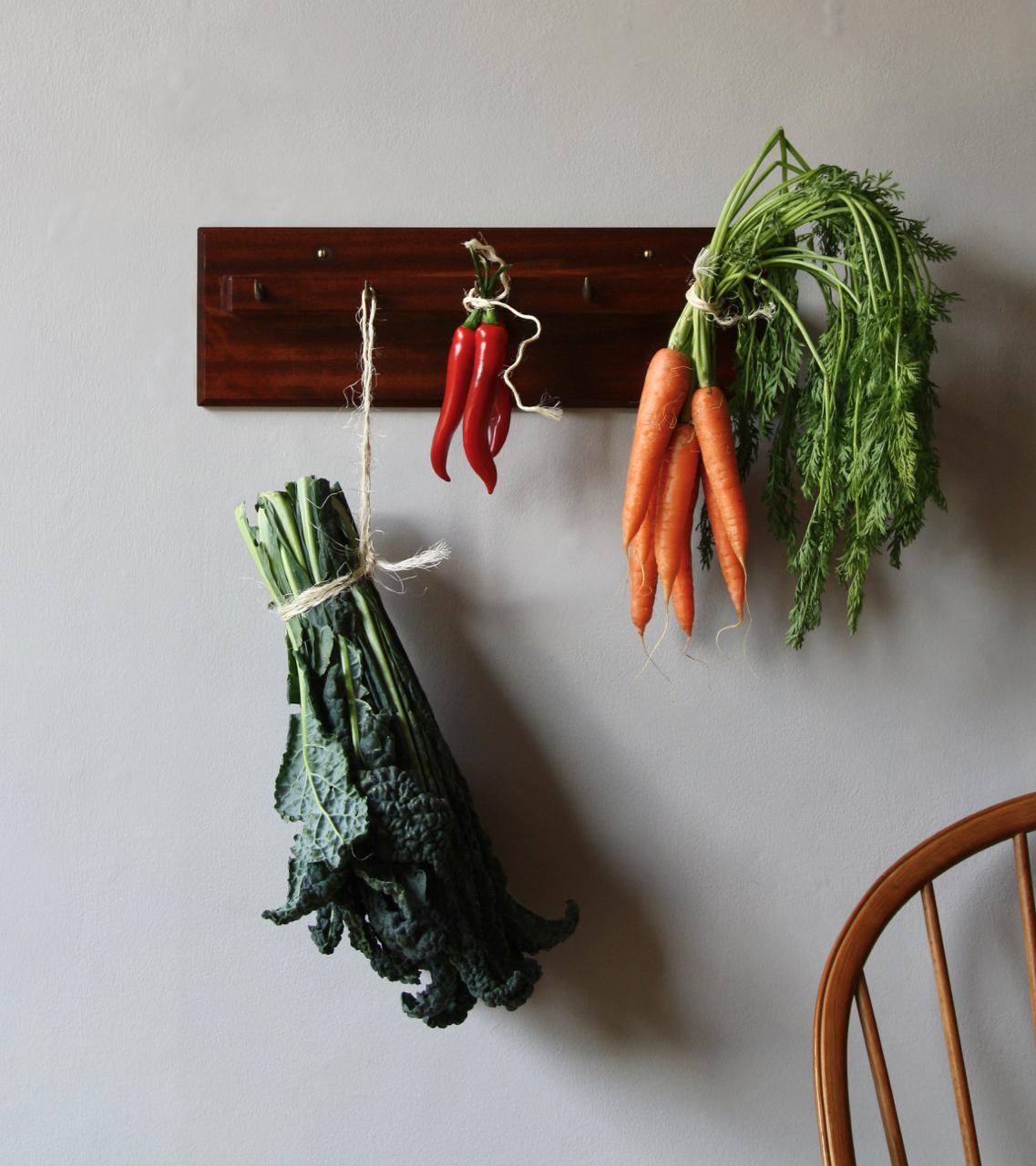 A vintage set of five metal hooks fixed within a wall mountable solid wood shelf.
The object was designed and made by Carl Auböck II, Austria, circa 1950 and was undoubtably intended to hold dried sausages/cuts of meat. Correspondingly, in the past