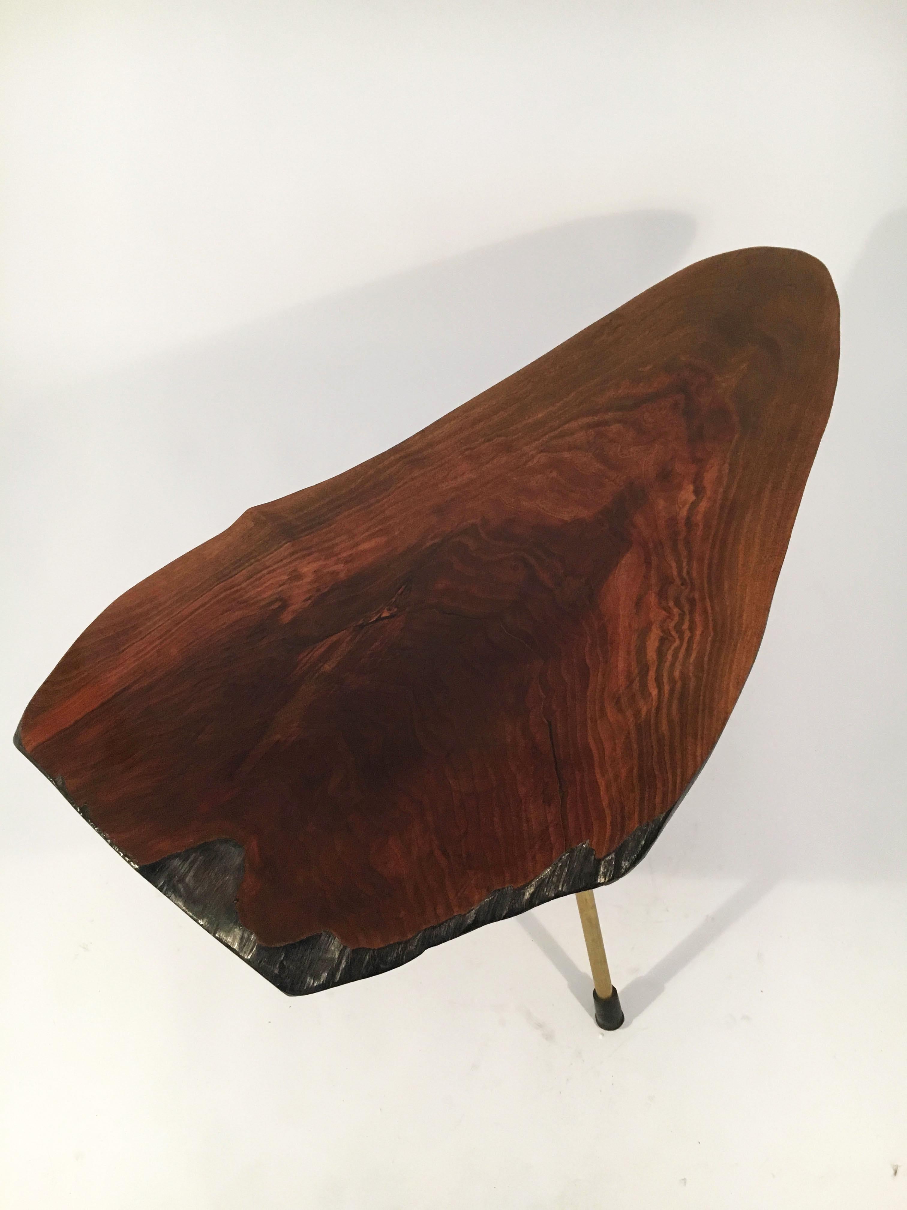 Gorgeous tree trunk table with a great color, shape and size by Carl Auböck, Austria, 1950s. In very good vintage condition with just the right amount of gently aged patina on the brass legs and the original shellac polish on the walnut trunk.