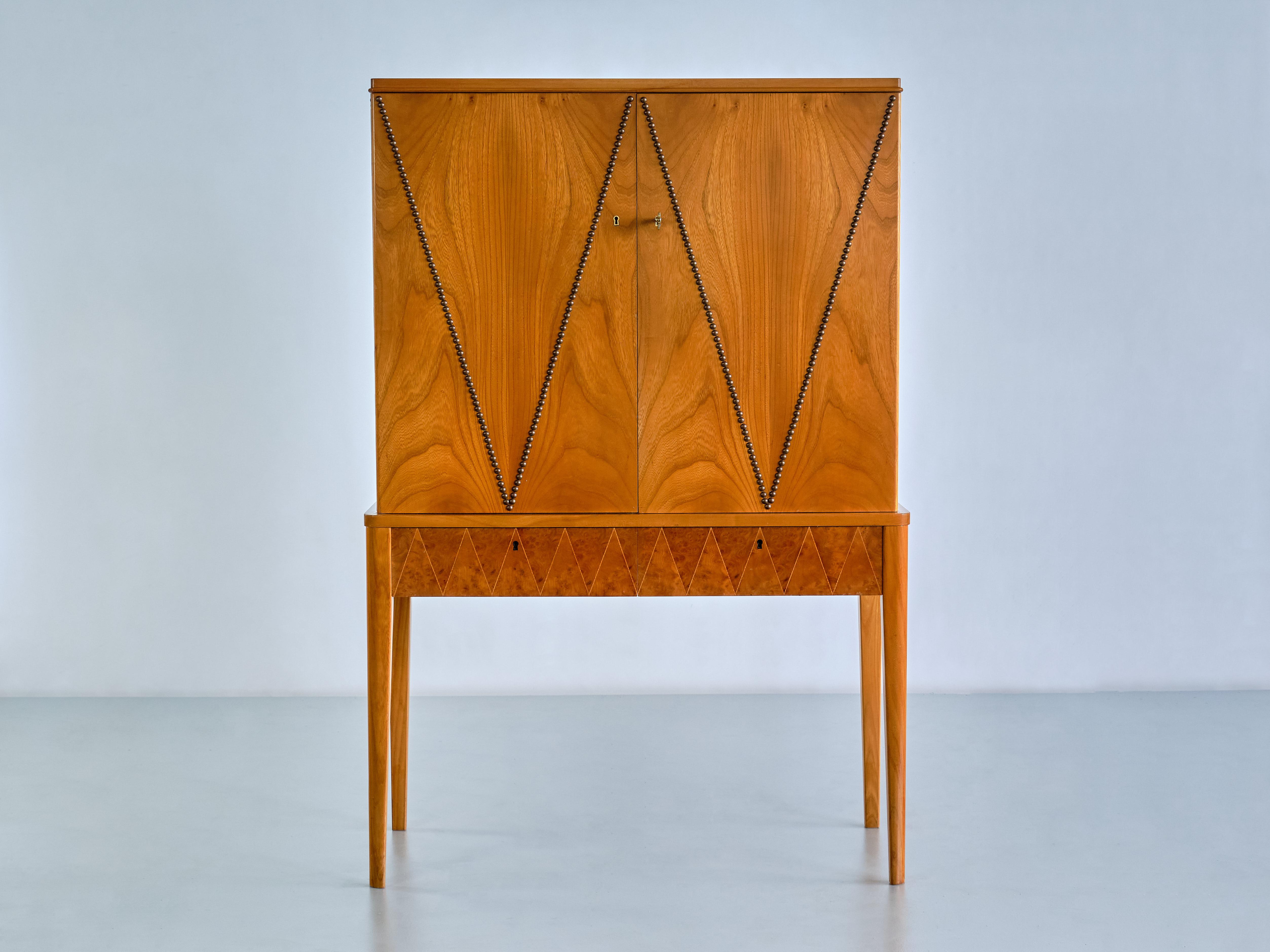 This very rare cabinet was produced by AB Svenska Möbelfabrikerna in Bodafors, Sweden in the late 1940s. The striking design is attributed to Carl-Axel Acking, one of the leading designers for SMF during this period. The piece is composed of a