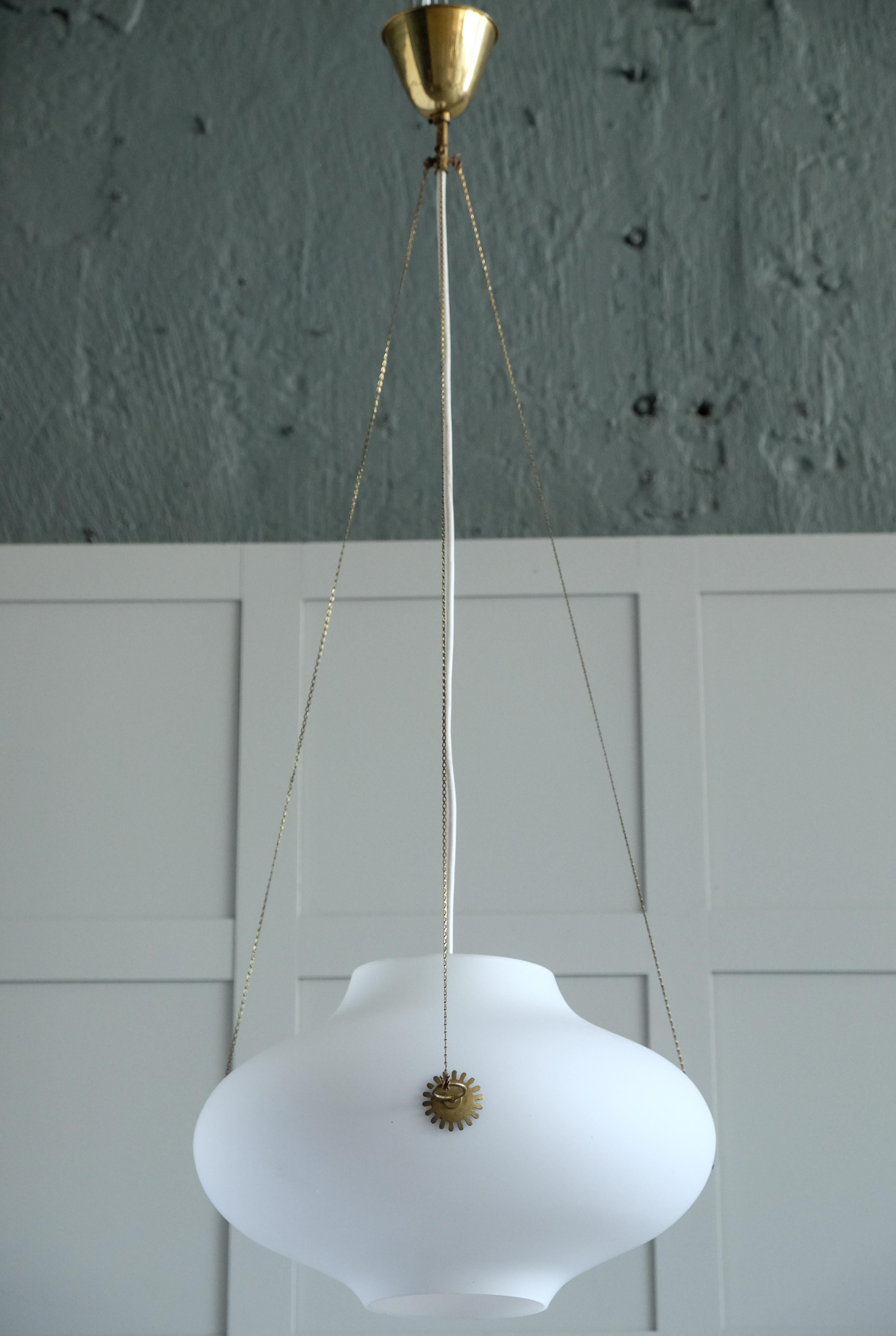 A rare brass & glass pendant designed by Carl Axel Acking, produced in Sweden, 1940s.