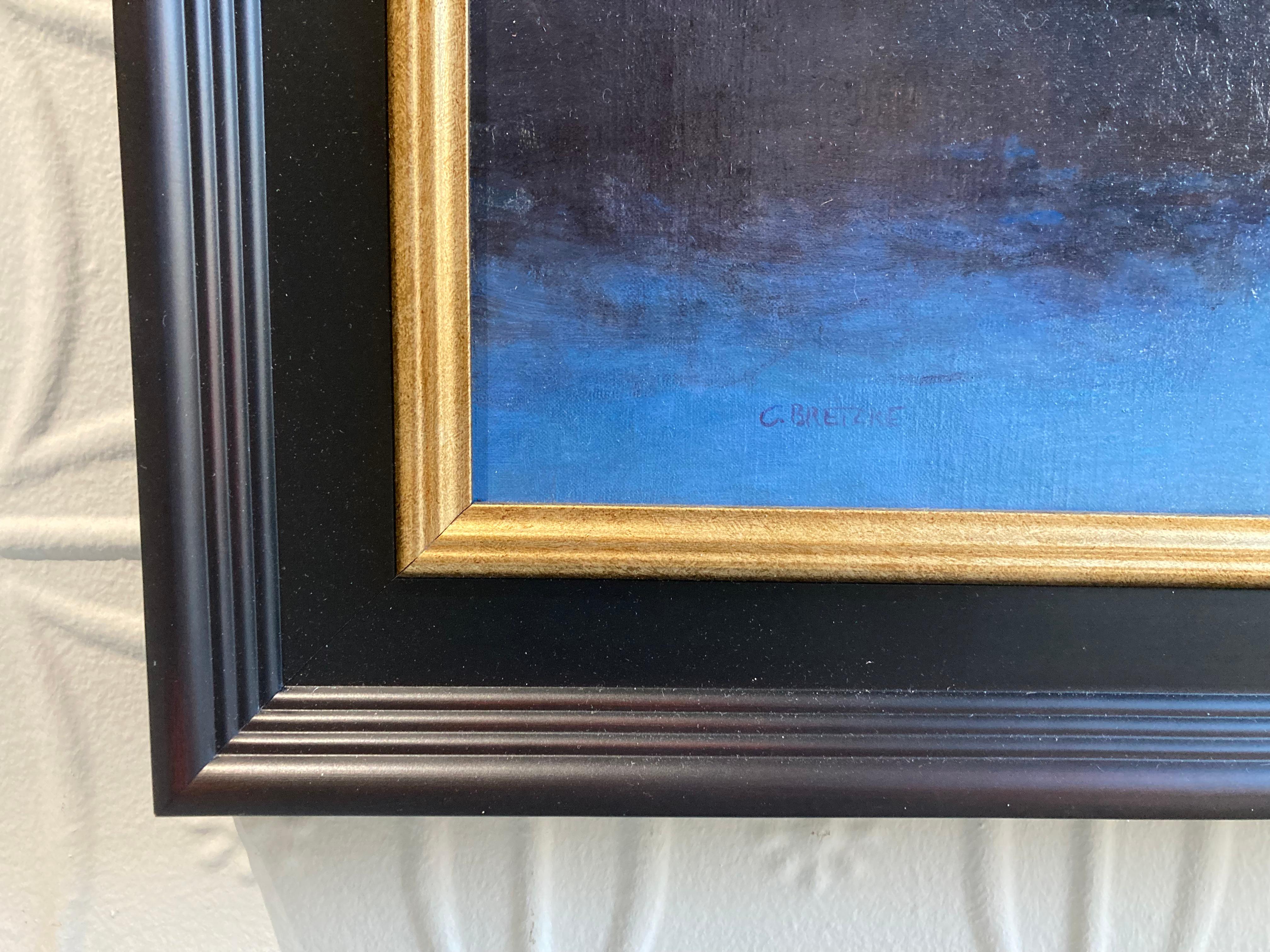 An oil painting of a cloud filled sky at sunset. The foreground is set along a sandy beach, white sand meeting dunes, tire tracks in the sand lead our eye to a pair of figures, seated on the beach, gazing up at the sky. The sun set has cast a bright