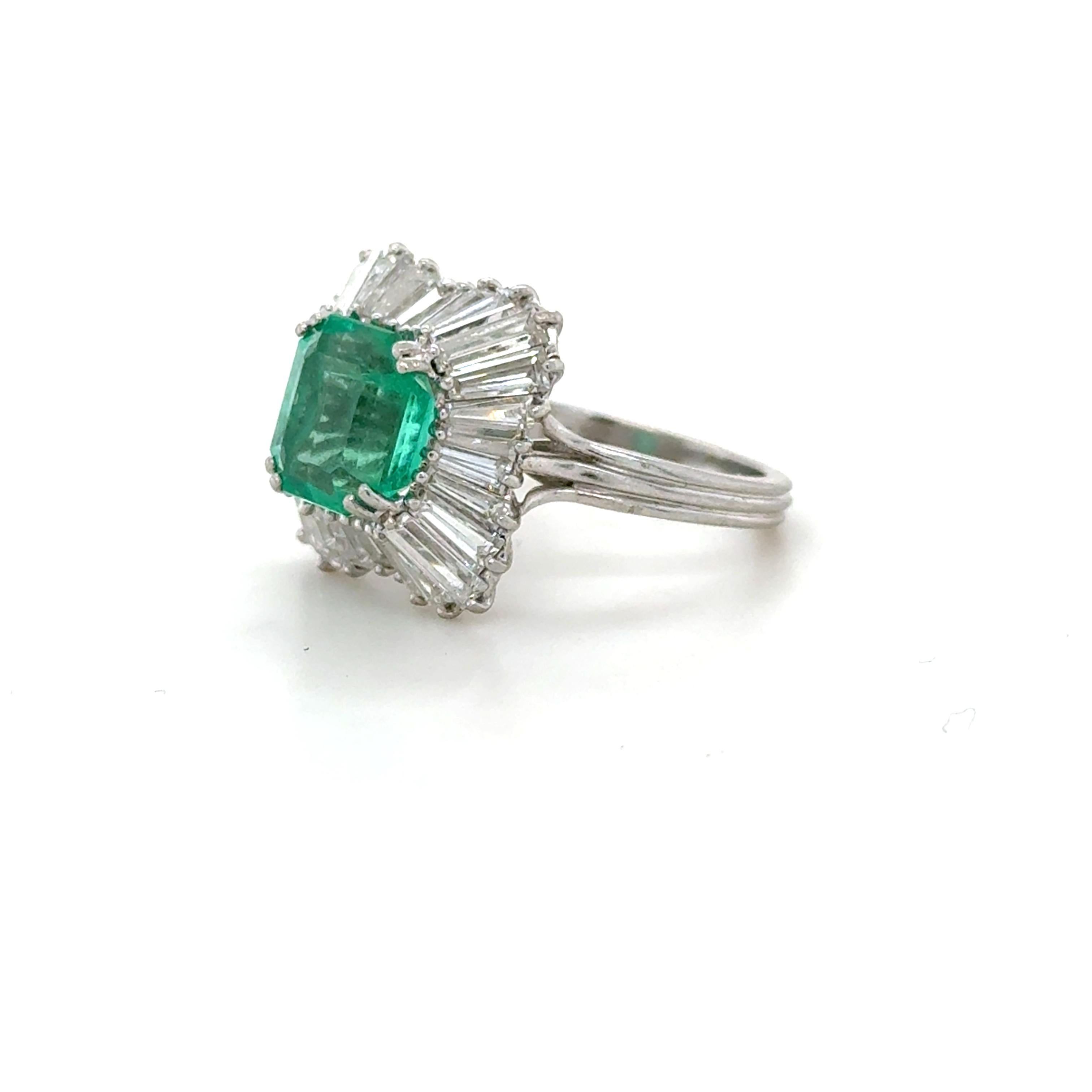 This fun cocktail ring boasts an emerald cut emerald weighing approximately 3.10 carats surrounded by 28 tapered baguette cut diamonds weighing approximately 2.50 carats total. Beautifully crafted in platinum, this ring is perfect for a party!

Ring
