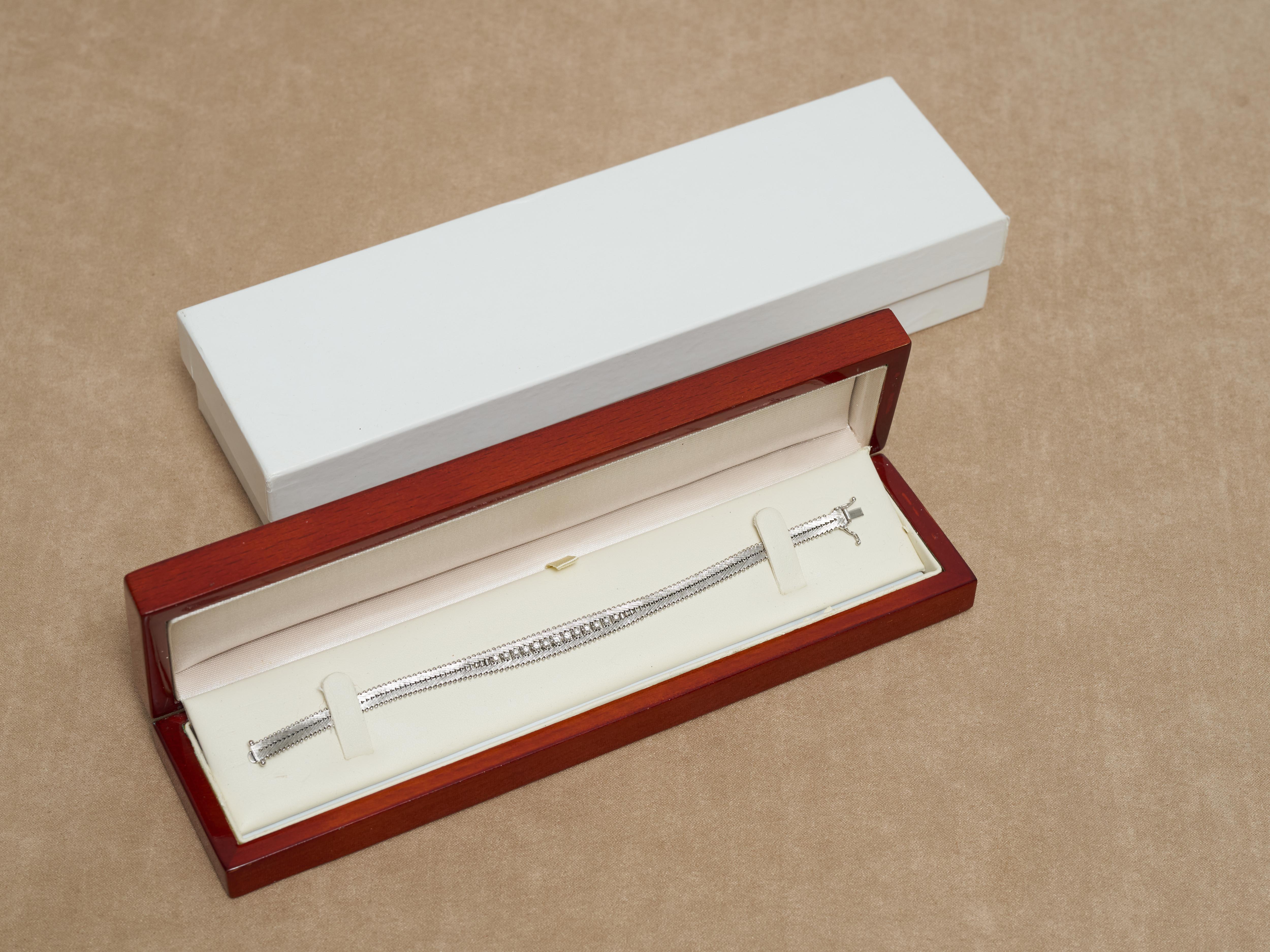 Highly intricate machine made Diamond Tennis Bracelet attributed to Carl Bucherer through the trademark CB750 makers mark of its time.



13 Graduated Diamonds Set in an articulated 18K White Gold Bracelet.



Over 0.5 Carats total Diamonds

19.4
