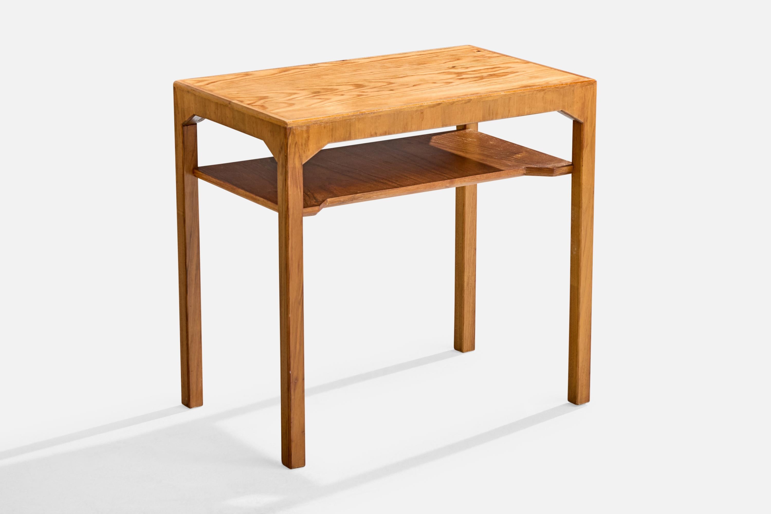 A walnut and pine side table designed by Carl Cederholm and produced by Firma Stil & Form, Sweden, c. 1940s.

Wear consistent with age and use

Overall Dimensions (inches): 20.5