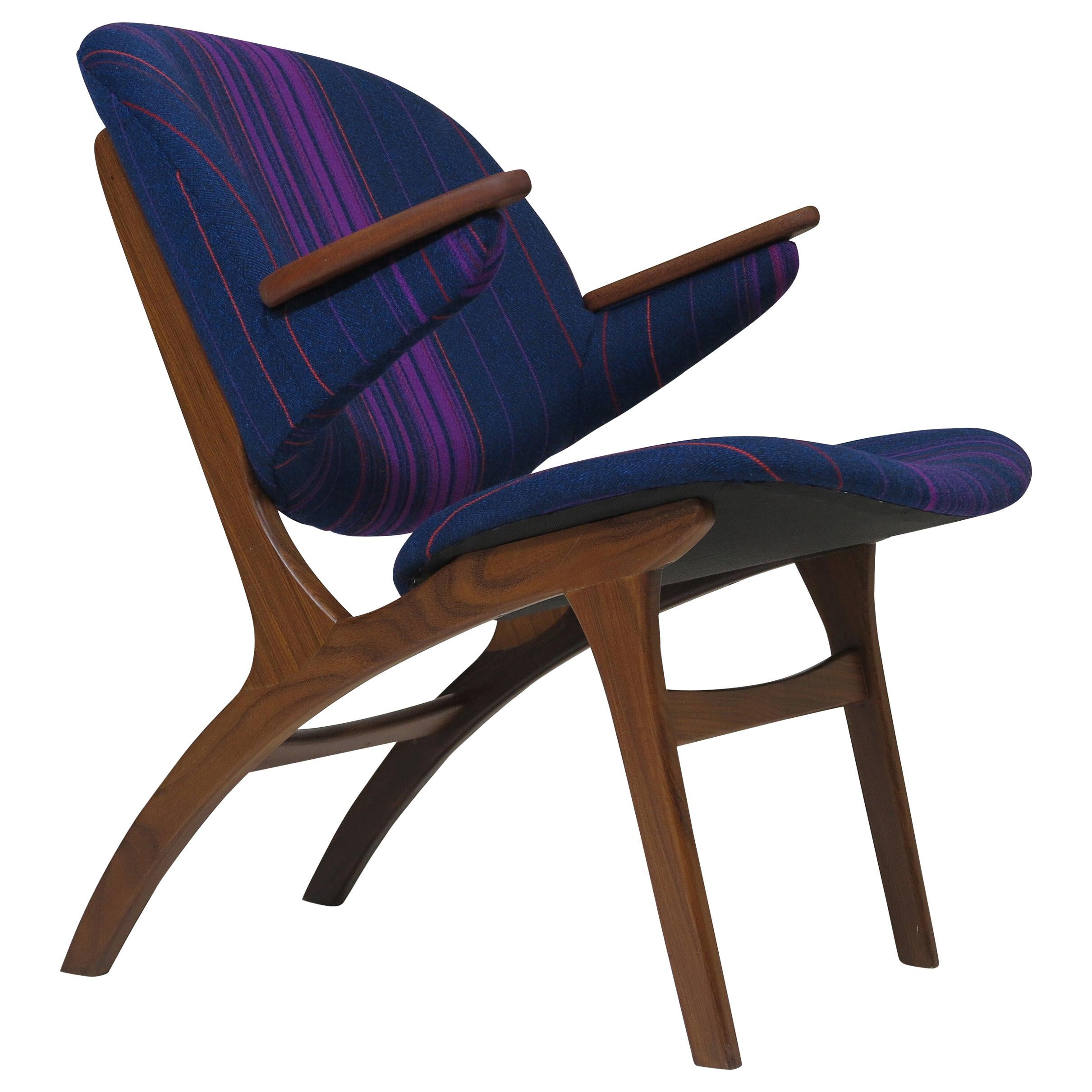 Pair of Edward Matthes for C.E. Matthes lounge chairs. Sculpted teak frame with comfortable curved back rest and teak arms, finely restored and reupholstered in an eye-catching striped wool fabric over natural latex foam.