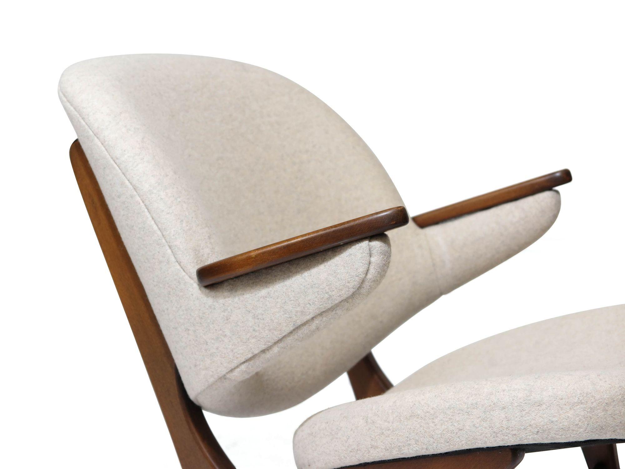 Carl Edward Matthes for C.E. Matthes lounge chair. Sculpted wood frame with comfortable curved back rest, newly reupholstered in an off-white wool textile. The wood frame is a walnut stain on beech wood, original finish, which has been cleaned and